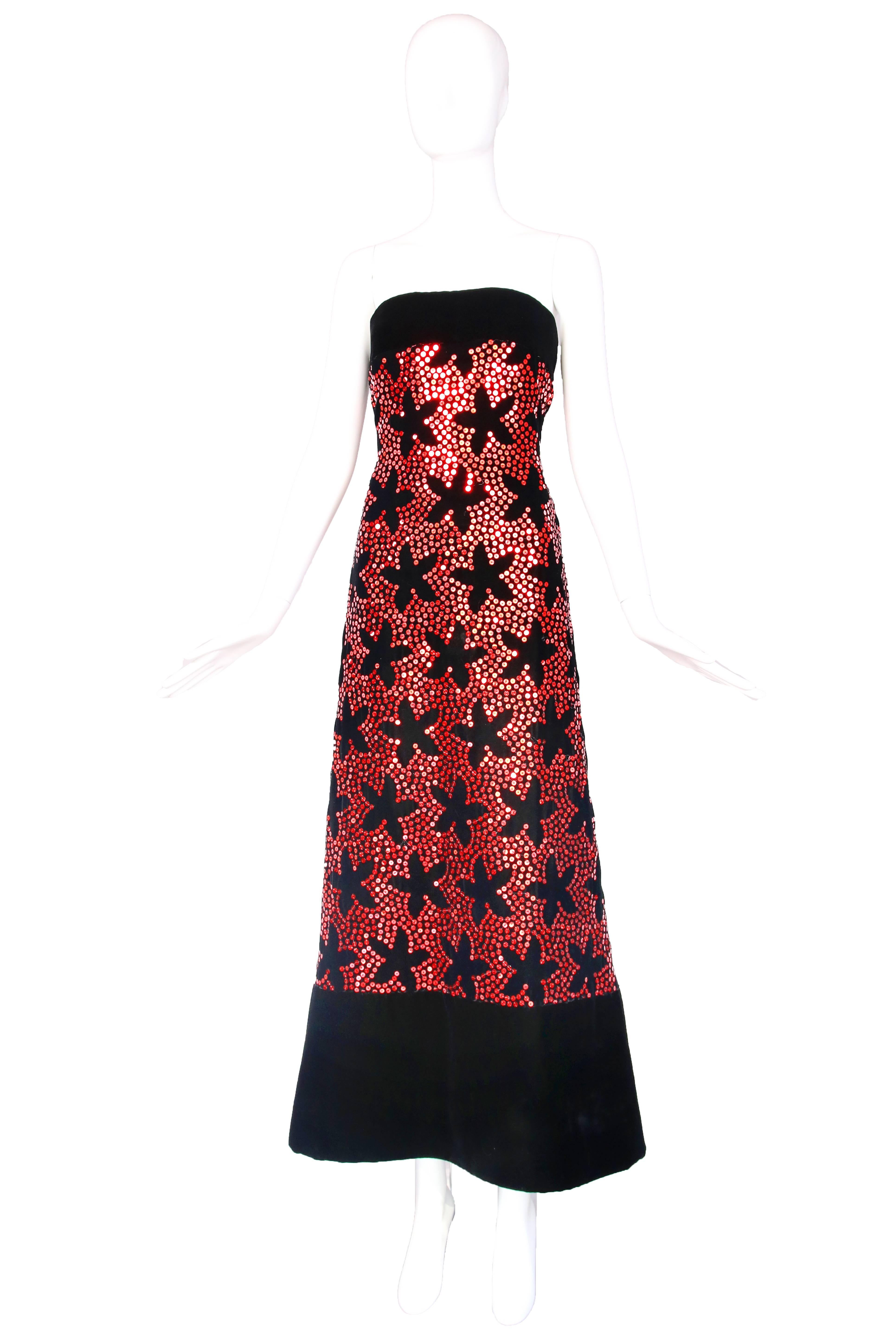 1980's Arnold Scaasi black velvet strapless evening gown with allover red sequin floral print. In excellent condition with minor sequin loss at back zipper. Size 6.
MEASUREMENTS:
Bust - 34