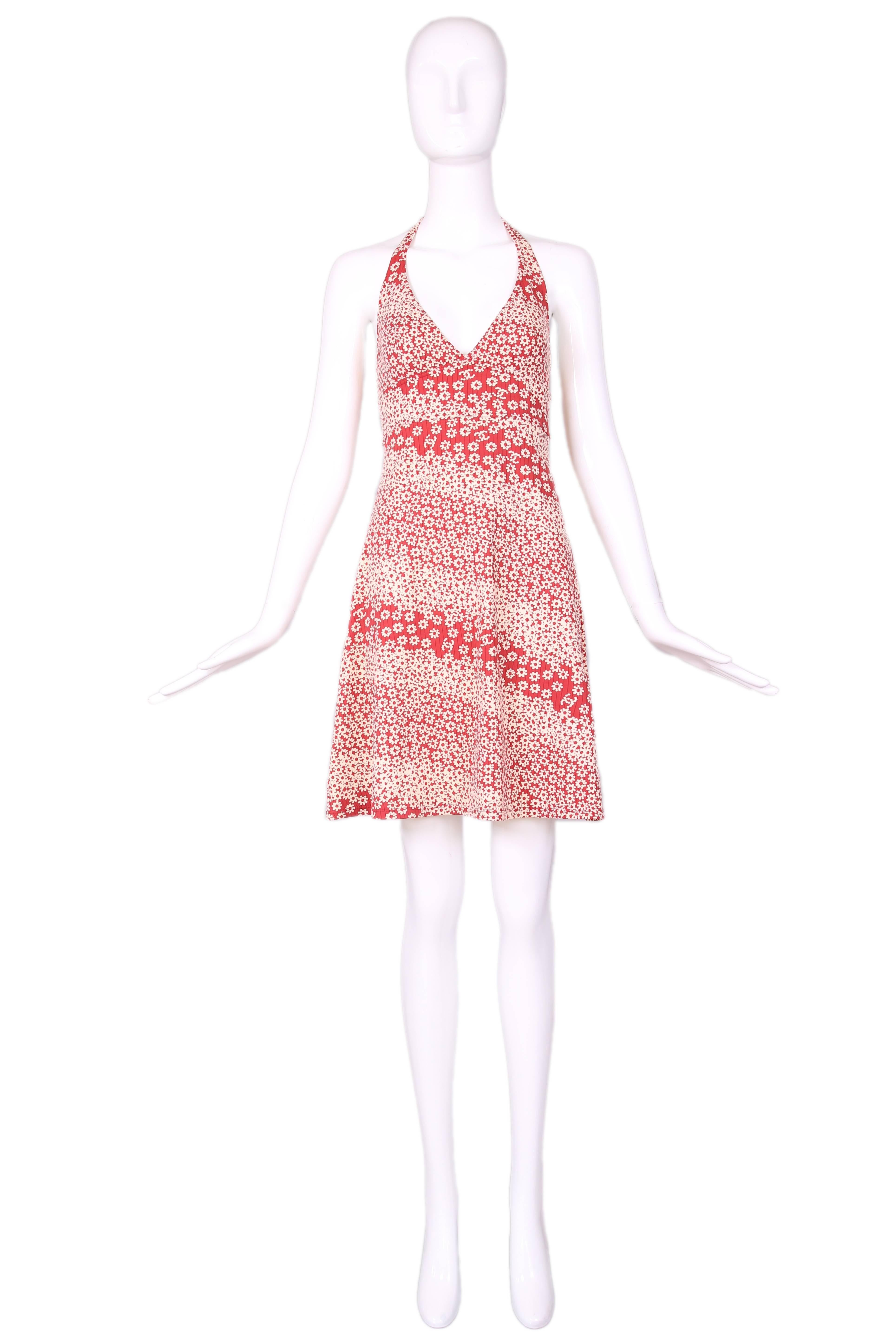 Chanel red & white floral print, stretch halter mini dress w/CC logo motif. In excellent condition. No size tag, please consult measurements.
MEASUREMENTS:
Bust - 30