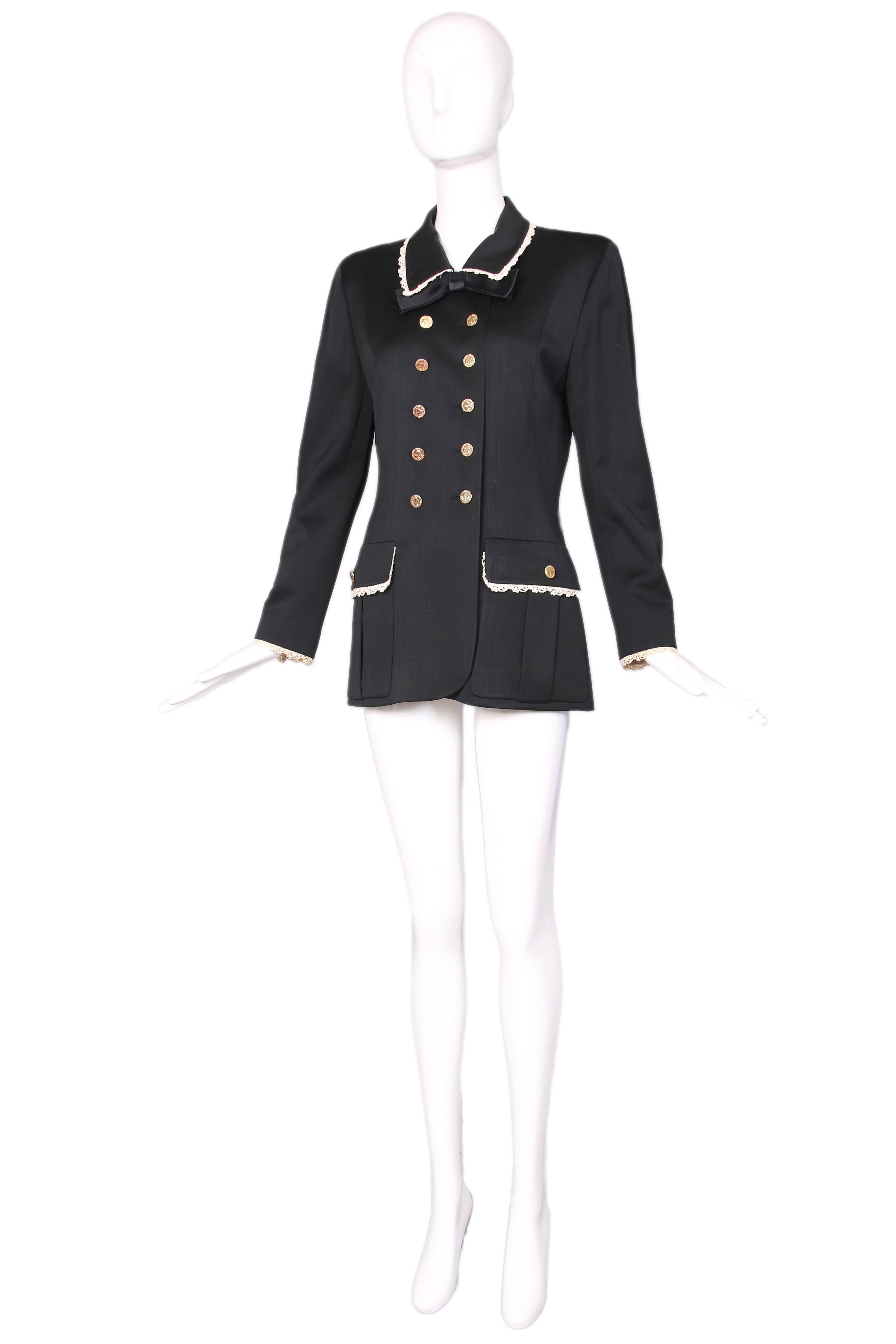 Vintage Chanel black double breasted light weight wool jacket with white crocheted lace trim at collar, sleeves, and pockets. Details include black satin bow at collar and gold toned Elephant themed Chanel buttons down the front, at pocket closure,