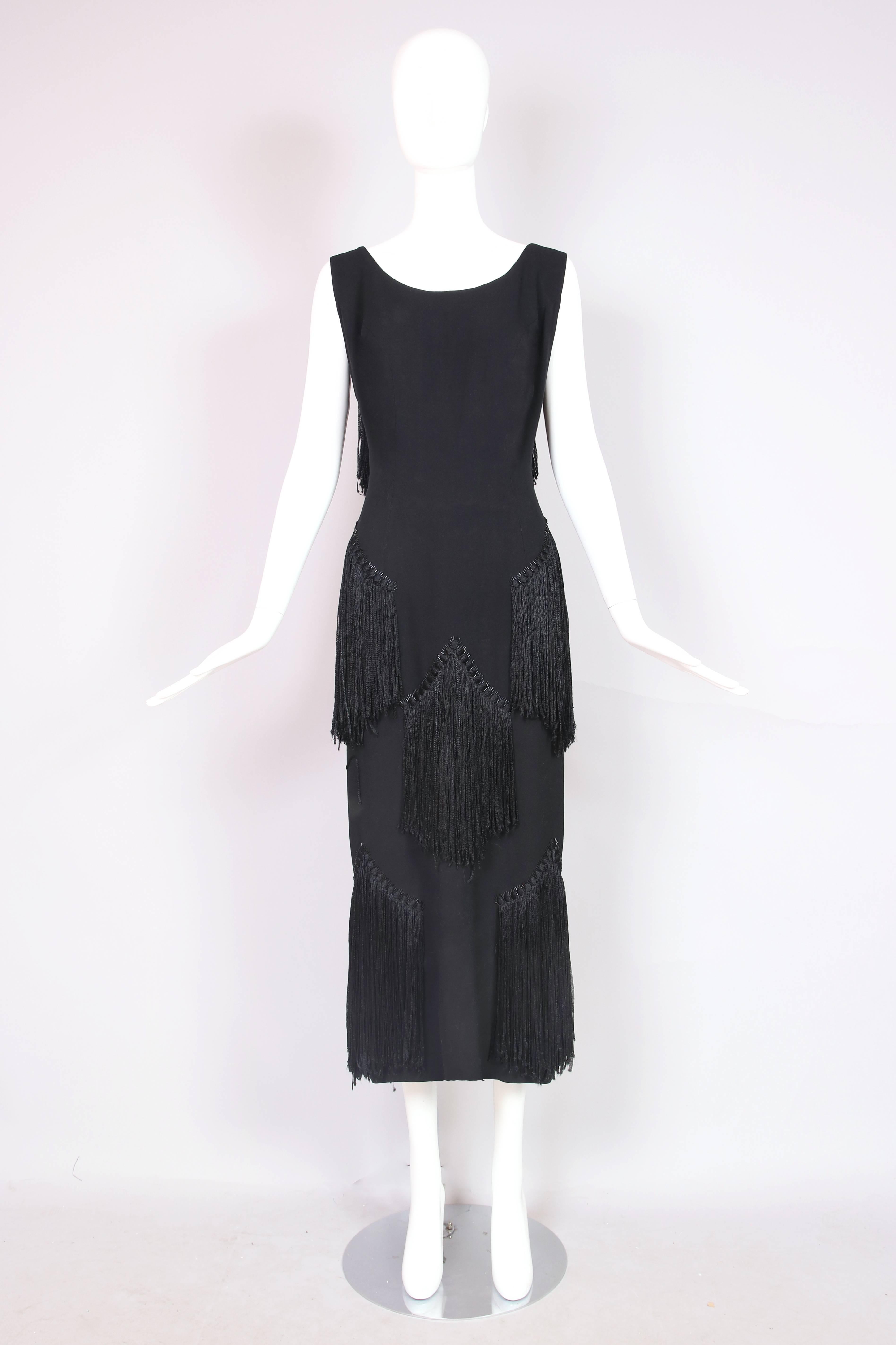 1940's House of Worth sleeveless black wool crepe dress with subtle scooped neckline, V-back and long black silk fringe panels and bugle beading detail. In excellent condition with one tiny start to a hole on the front bodice and minor wear to the
