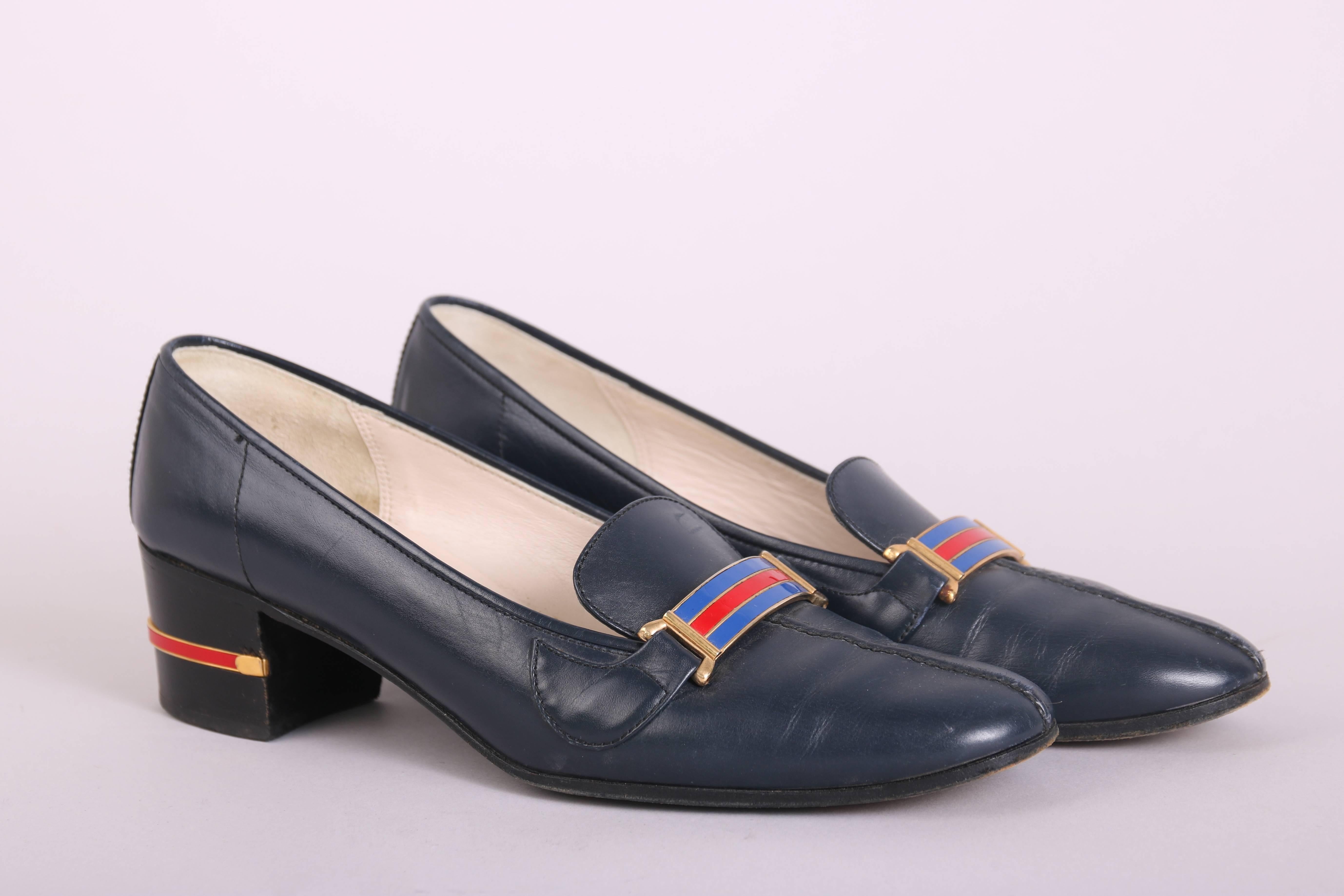 1970's Gucci navy leather heeled loafers with gold tone hardware and a red & blue enameled bar at the top. Leather is quite soft and In very good condition with some extremely light scuffs at the toe and wear at the bottom of the soles ***please