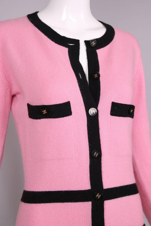 pink cardigan with black trim