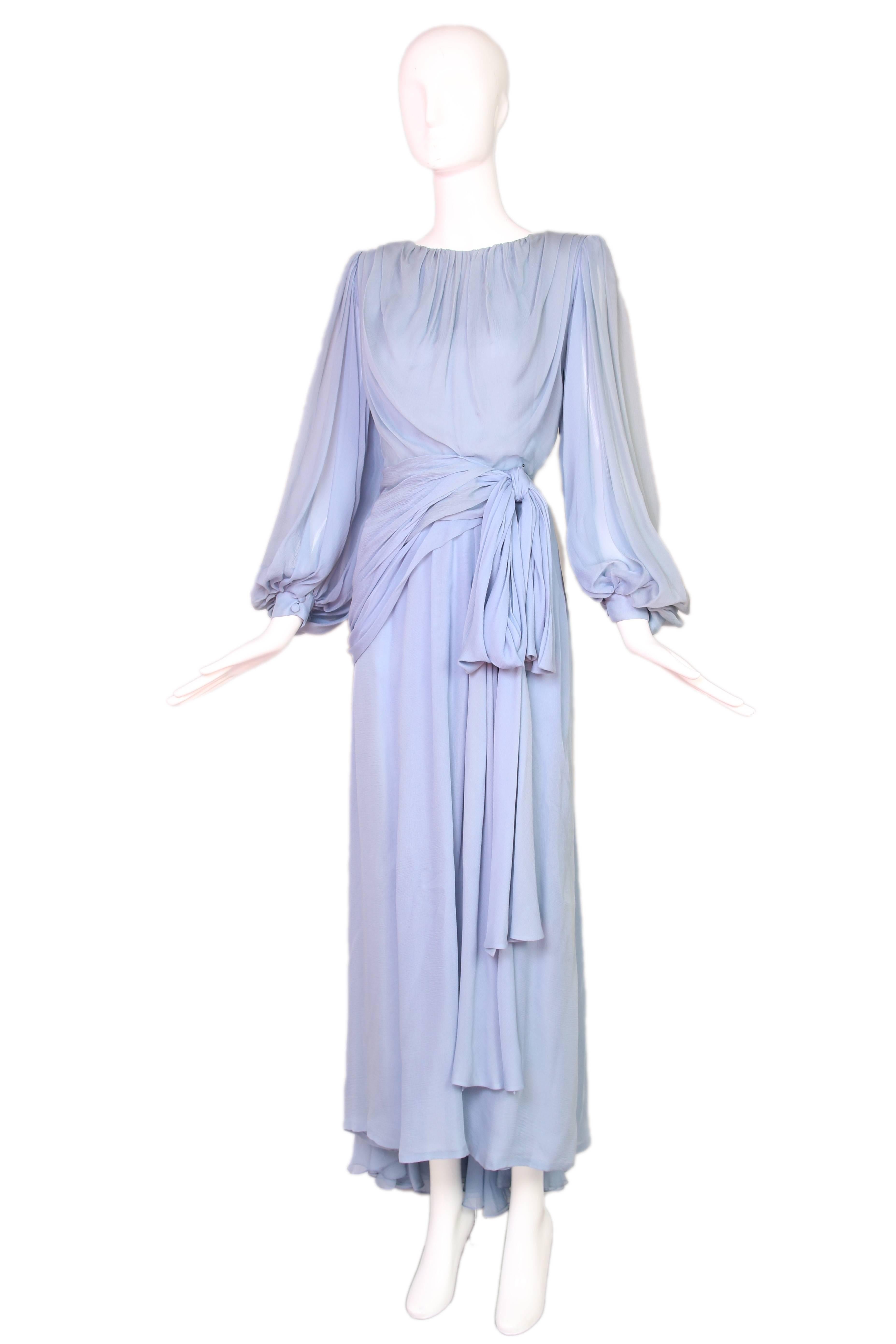 1987 A/H Yves Saint Laurent haute couture periwinkle blue silk chiffon evening gown with meticulous pleating, multiple chiffon layers, bishop sleeves and an attached sash/belt. Included is the original runway photo - see photos. In very good
