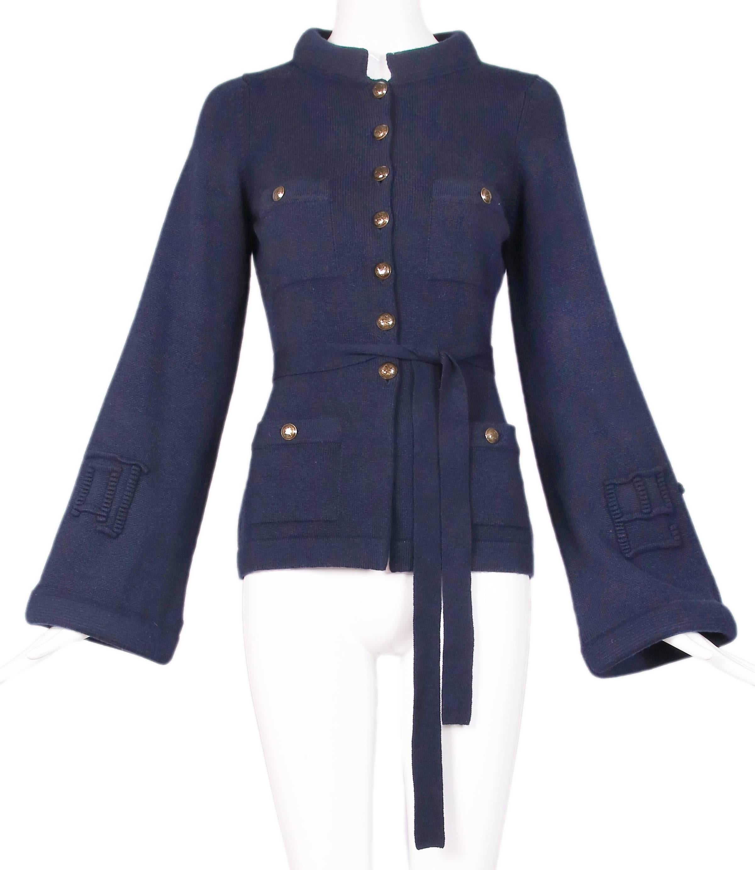 2010 Chanel "Metiers D'Art" collection navy cashmere blend cardigan sweater with waist tie, frontal pockets, glazed metallic logo buttons and rolled Nehru collar. Sweater features bell sleeves embellished with raised Chinese