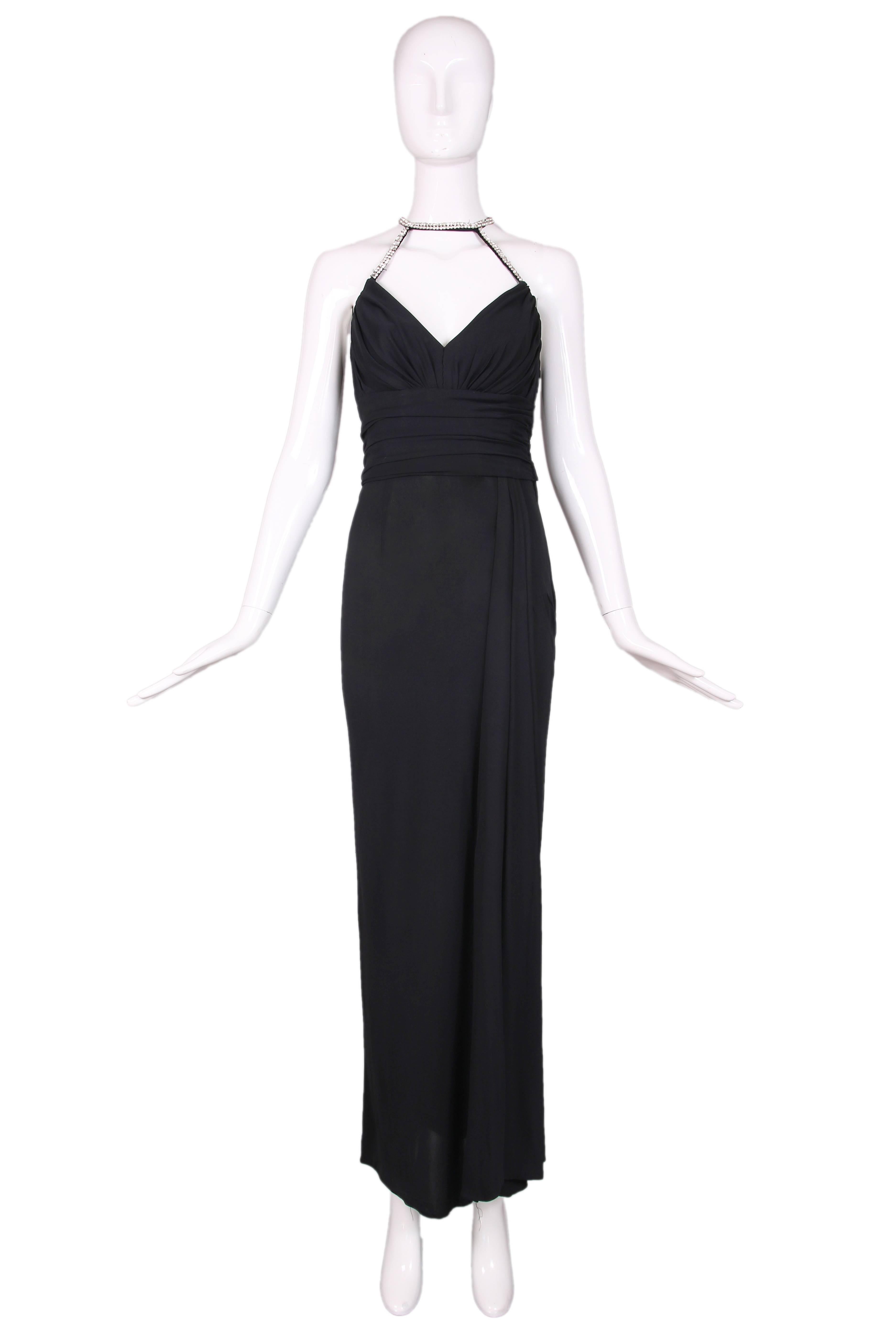 1998-1999 A/H Chanel black cotton jersey evening gown with rhinestone straps off sweetheart neckline that circle the neck and continue at back. Features slight side ruching at fitted waist and a draped panel just to the left of center front,