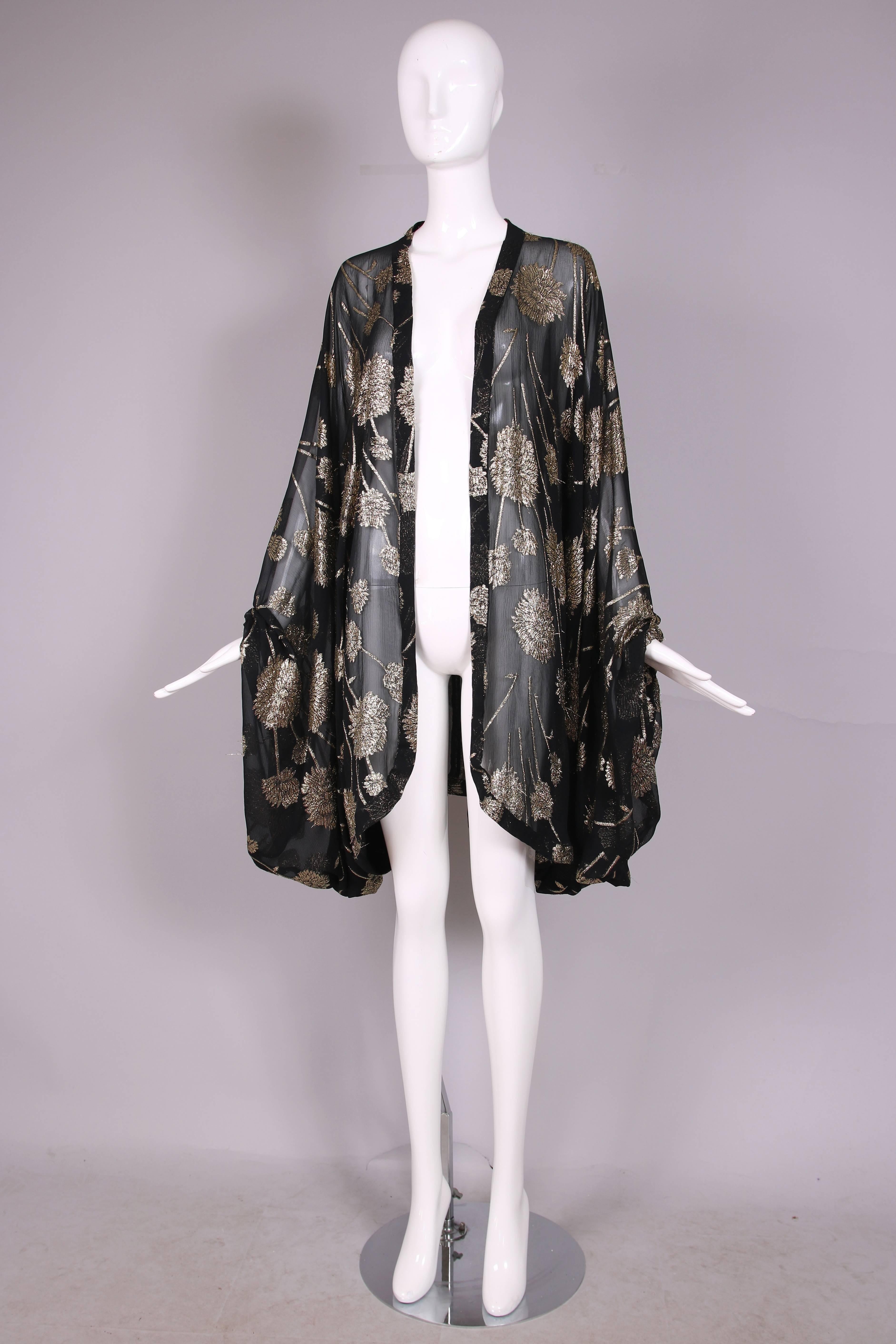 Vintage sheer black and gold metallic floral print silk chiffon cocoon shaped shawl with elastic armholes. In excellent condition. No tag.
MEASUREMENTS:
Length - 36