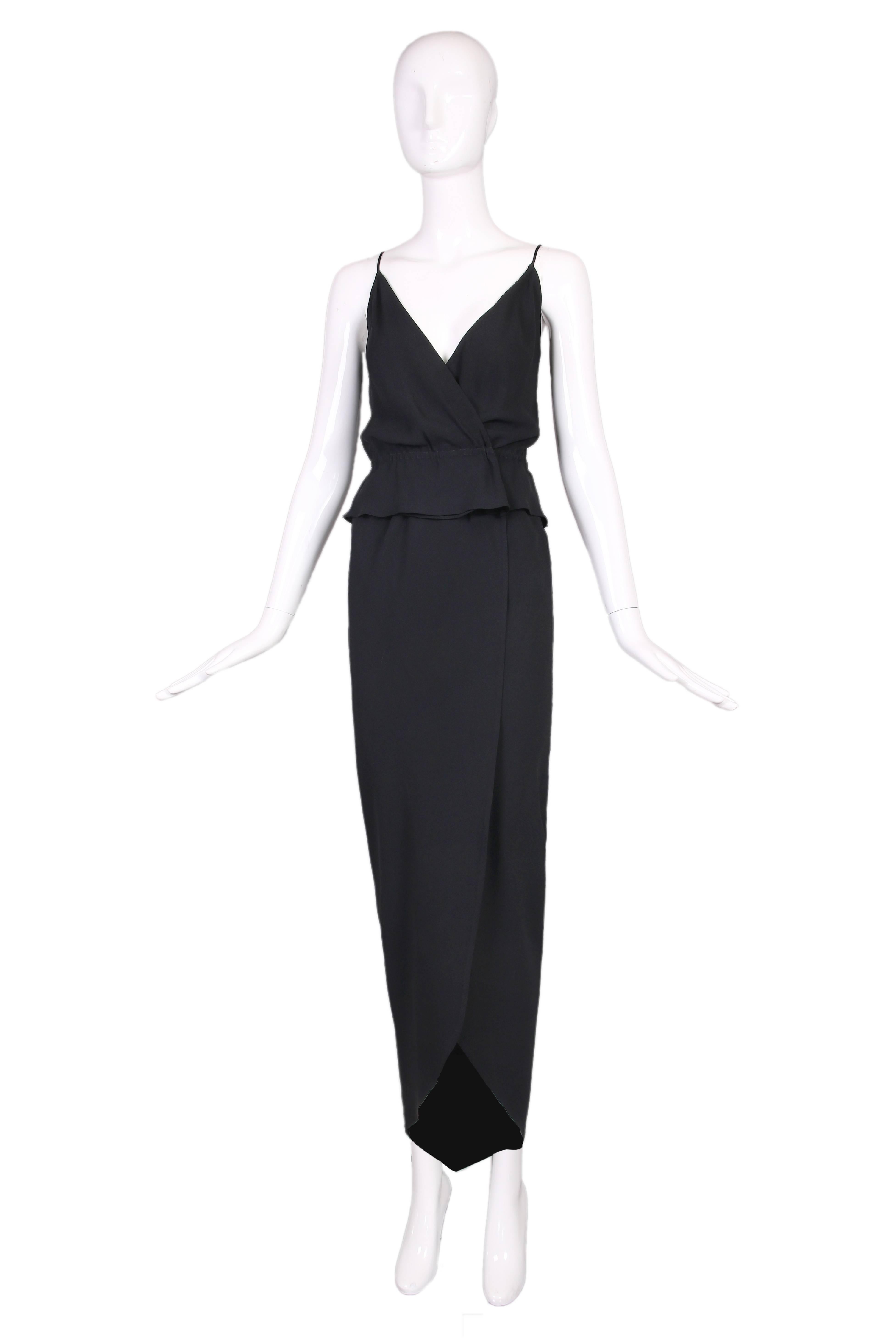1970's Halston black silk crepe 2-piece consisting of a low V-neck spaghetti strap top and tulip silhouette faux-wrap skirt. In excellent condition.
Top:
Bust - 34"
Waist - 26"
Skirt:
Waist - 28"
Hip - 38"
Length - 48"