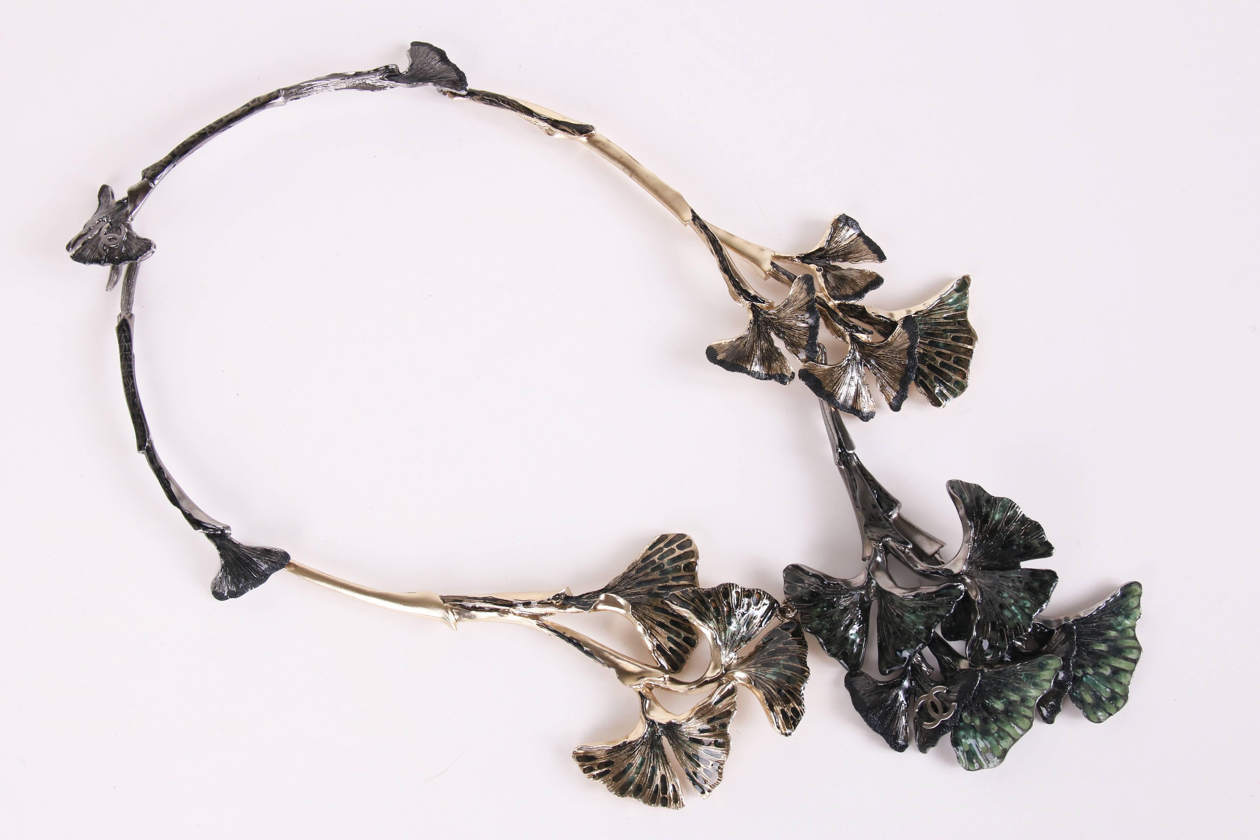 2011 Spring/Summer Chanel hand-enameled ginkgo leaf motif collar necklace in shades of bronze and gold tone metal and gloss lacquer finish. The necklace is assembled out of linked sections featuring sculpturally rendered ginkgo leaves  hand-enameled