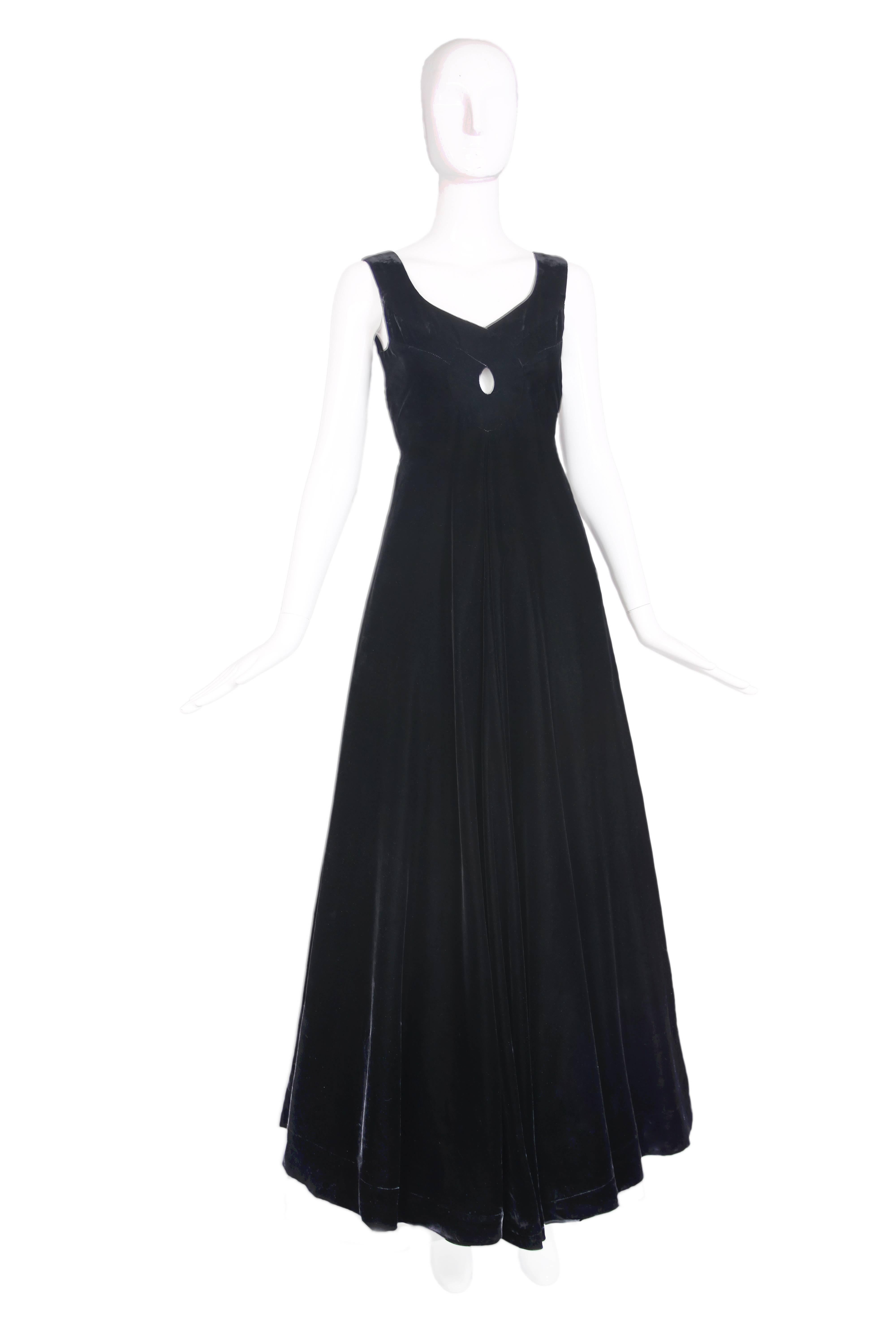 1960's Madame Grés demi-couture black velvet evening gown featuring center front and back keyhole. Separate voluminous taffeta slip skirt. In very good condition - some minor wear to the velvet and to the hook and eye closures at shoulder strap.