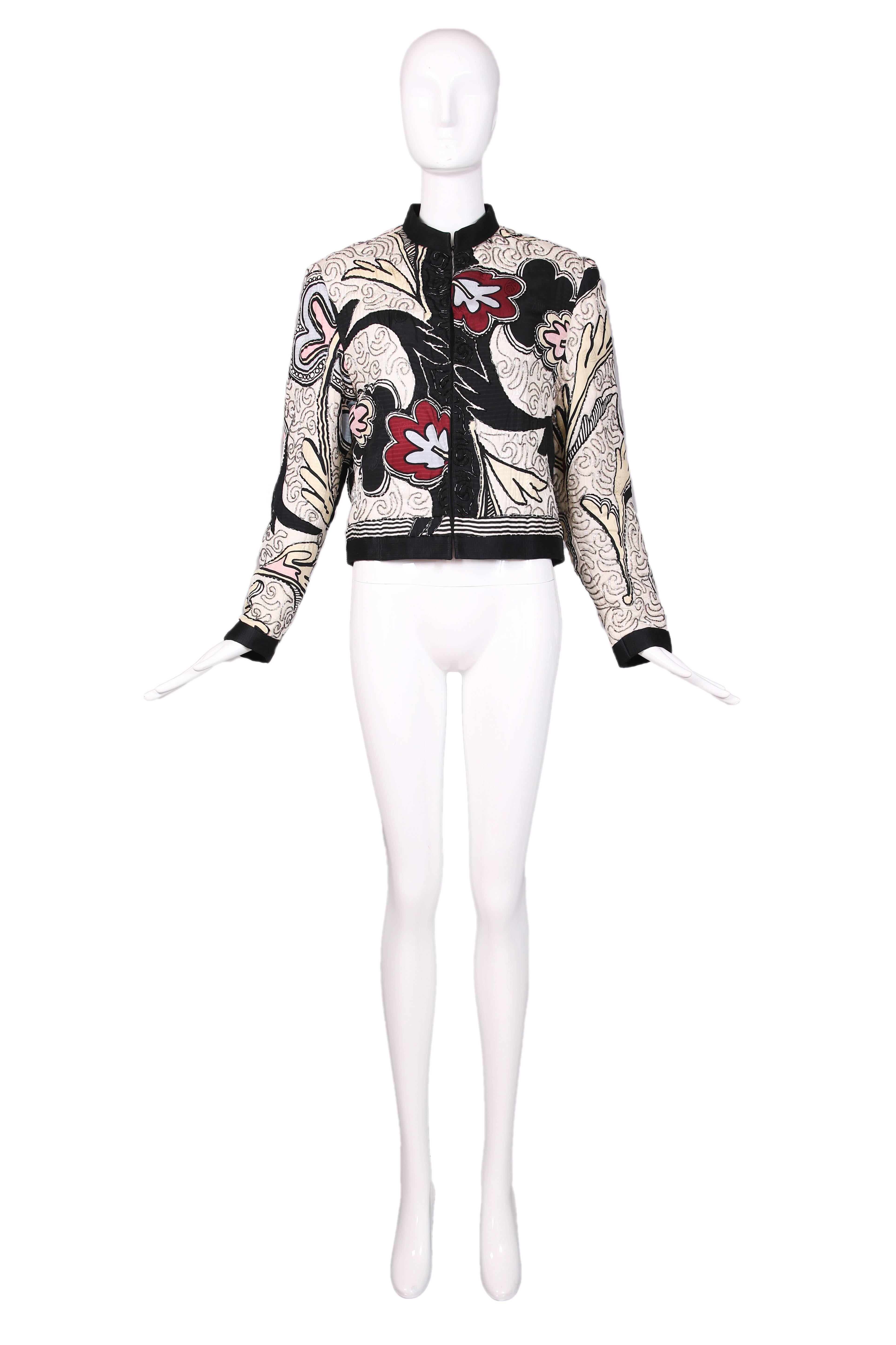 Michaele Vollbracht silk beaded abstract print jacket with black trim and hook & eye closures down the front. Jacket embellished throughout with silver and black bugle beads. "Michaele Vollbrach" signature printed at back. Fully lined