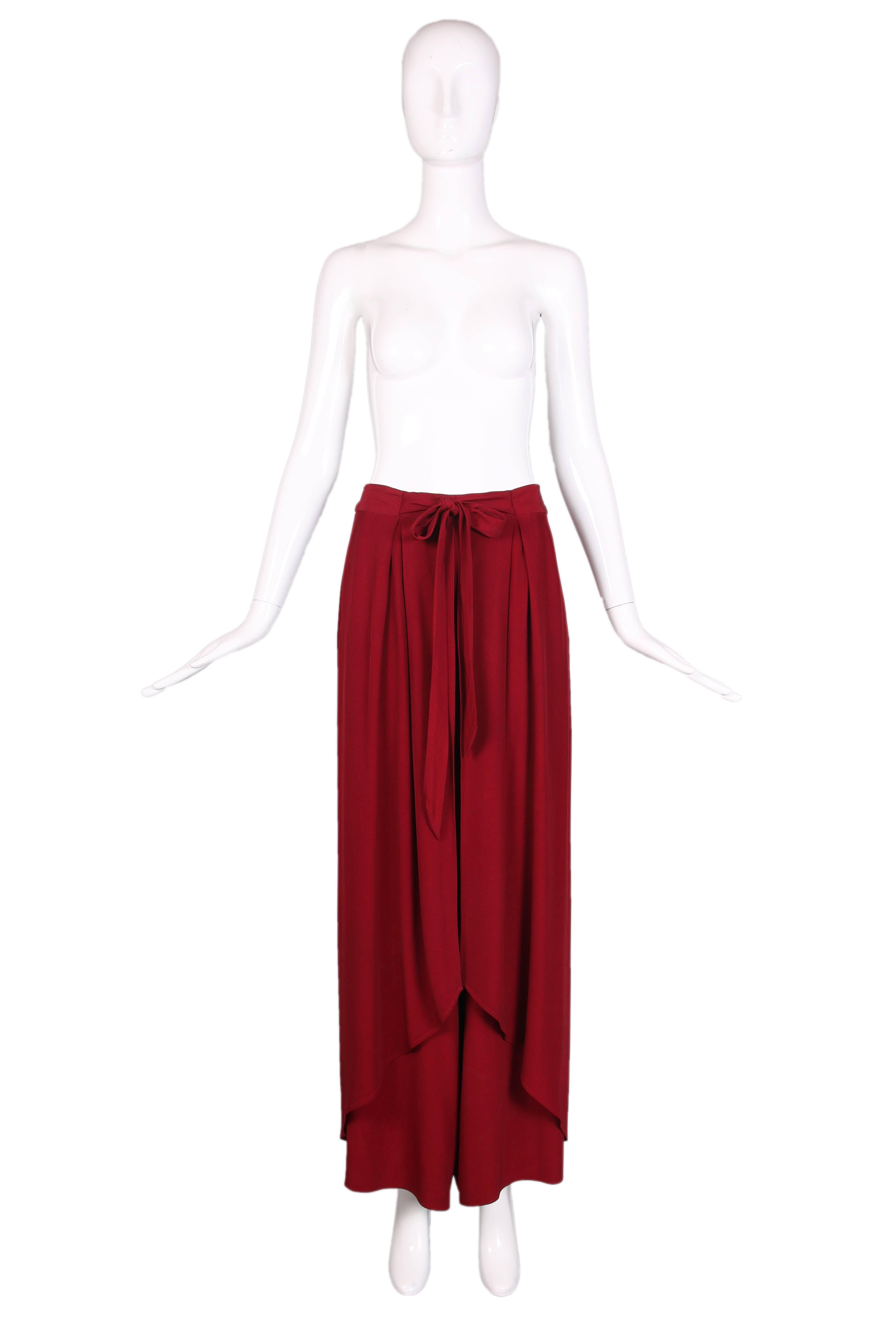 Christian Lacroix burgundy high waisted wrap palazzo pants featuring a waist tie, back button fastening, back zipper, two side pockets and a wide leg. In excellent condition with a few hidden dark marks on the inner lining.
Size EU