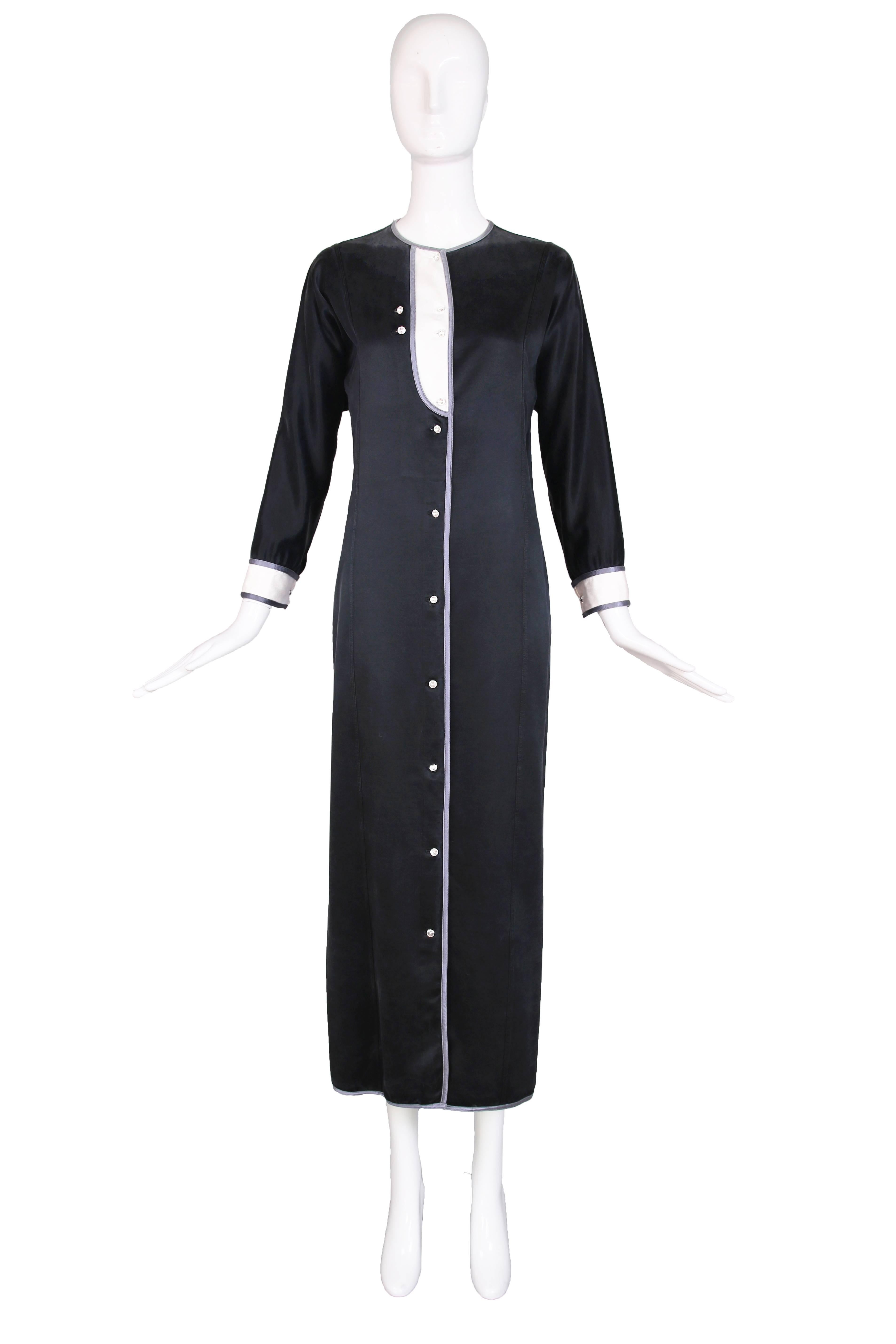 1970's Geoffrey Beene satin tuxedo dress with crystal buttons down the front and at the cuffs and silver satin trim. In excellent condition. No size tag, please consult measurements.
MEASUREMENTS:
Bust - 38