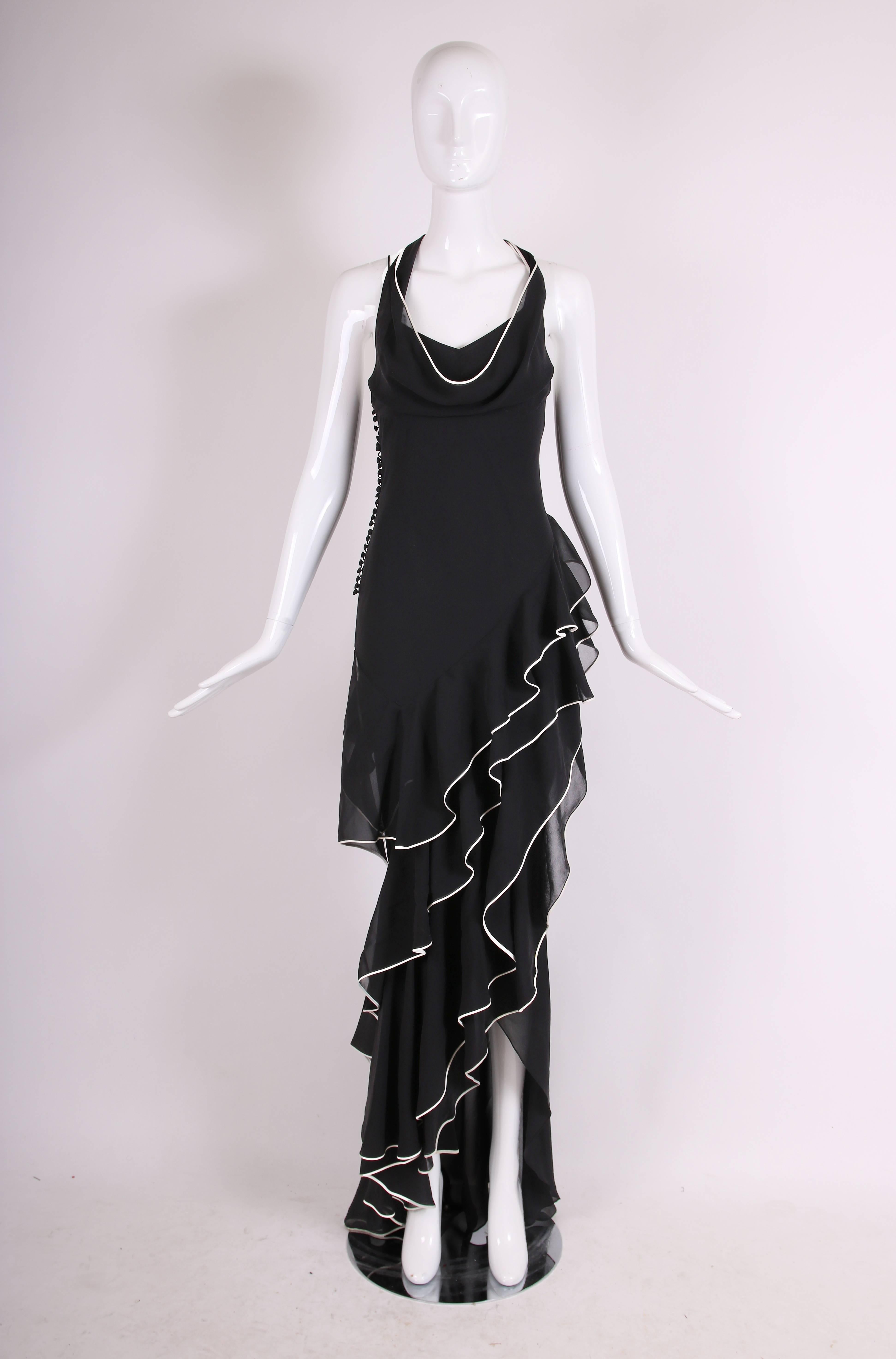2005 Christian Dior by John Galliano black silk crepe chiffon evening gown with creme piping, featuring four layers of bias-cut ruffles at front. Bodice is double layered featuring spaghetti straps and a halter neck line. Covered button closure at