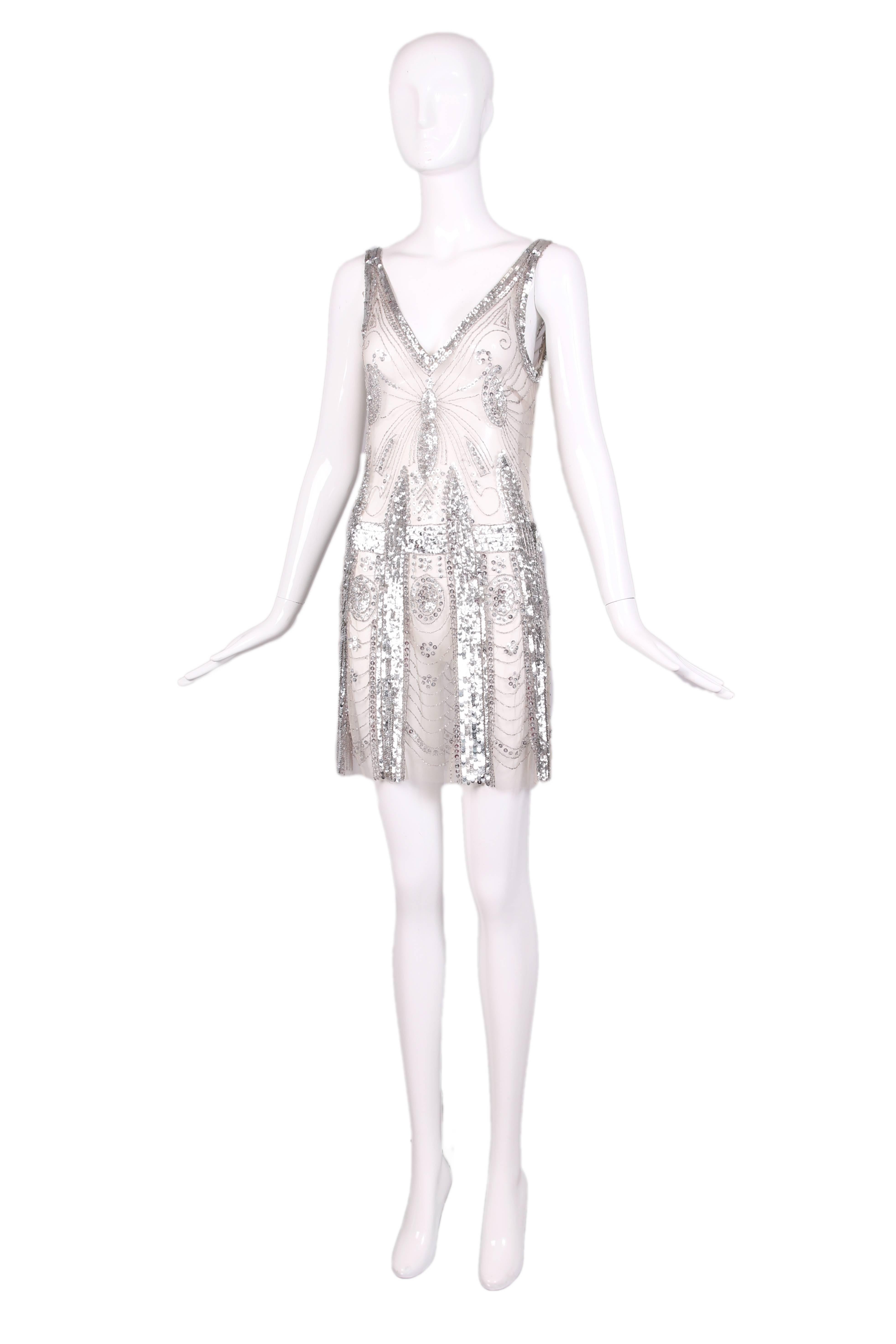 Pierre Balmain sheer cocktail dress embellished with silver sequins and clear bugle beads. Mirrored V-neckline in the front and back. In excellent condition. Size IT 40.
MEASUREMENTS:
Bust - 34"
Waist - 28"
Hip - 40"
Length -