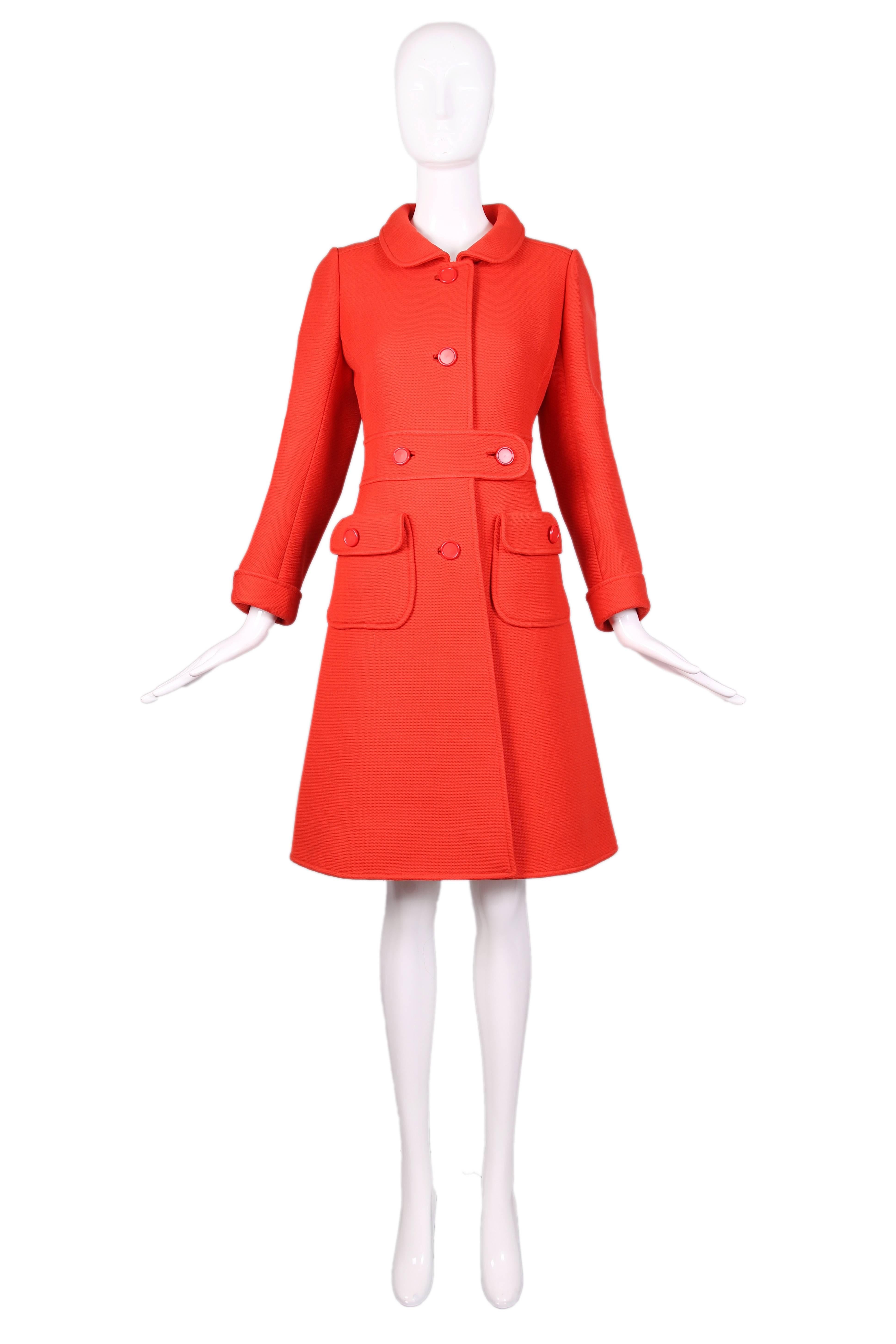 1960's Courreges haute couture orange wool A-line mod coat with orange buttons and two front pockets. In excellent condition with a few tiny pulls. No size tag, please consult measurements.
MEASUREMENTS:
Bust - 36