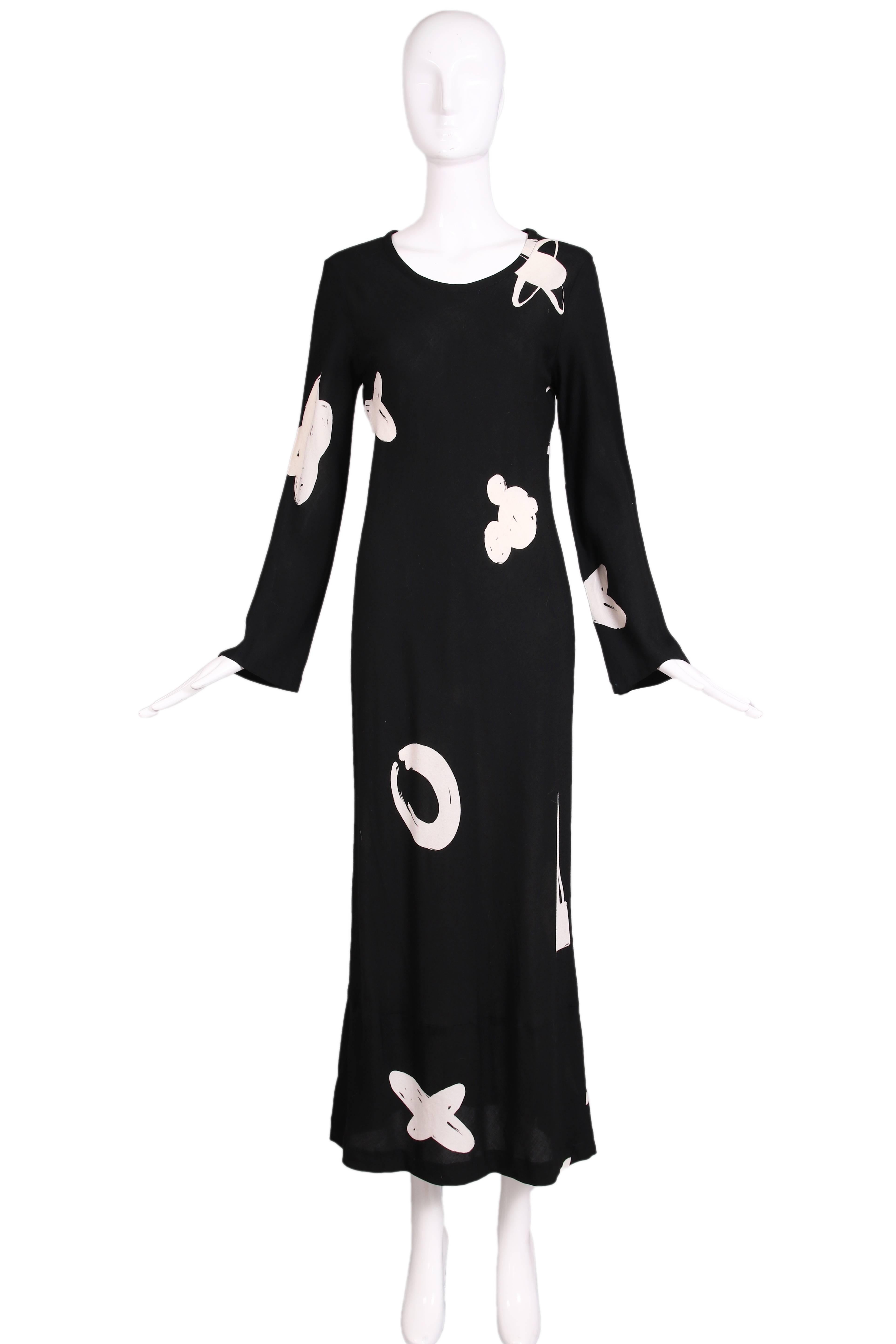 Rare 1980's Comme de Garcons with Robe de Chambre label. This dress is a black cotton maxi with long sleeves, a scooped neckline and featuring a white abstract interpretations of planets, mickey mouse, airplanes, etc.  In excellent condition. No