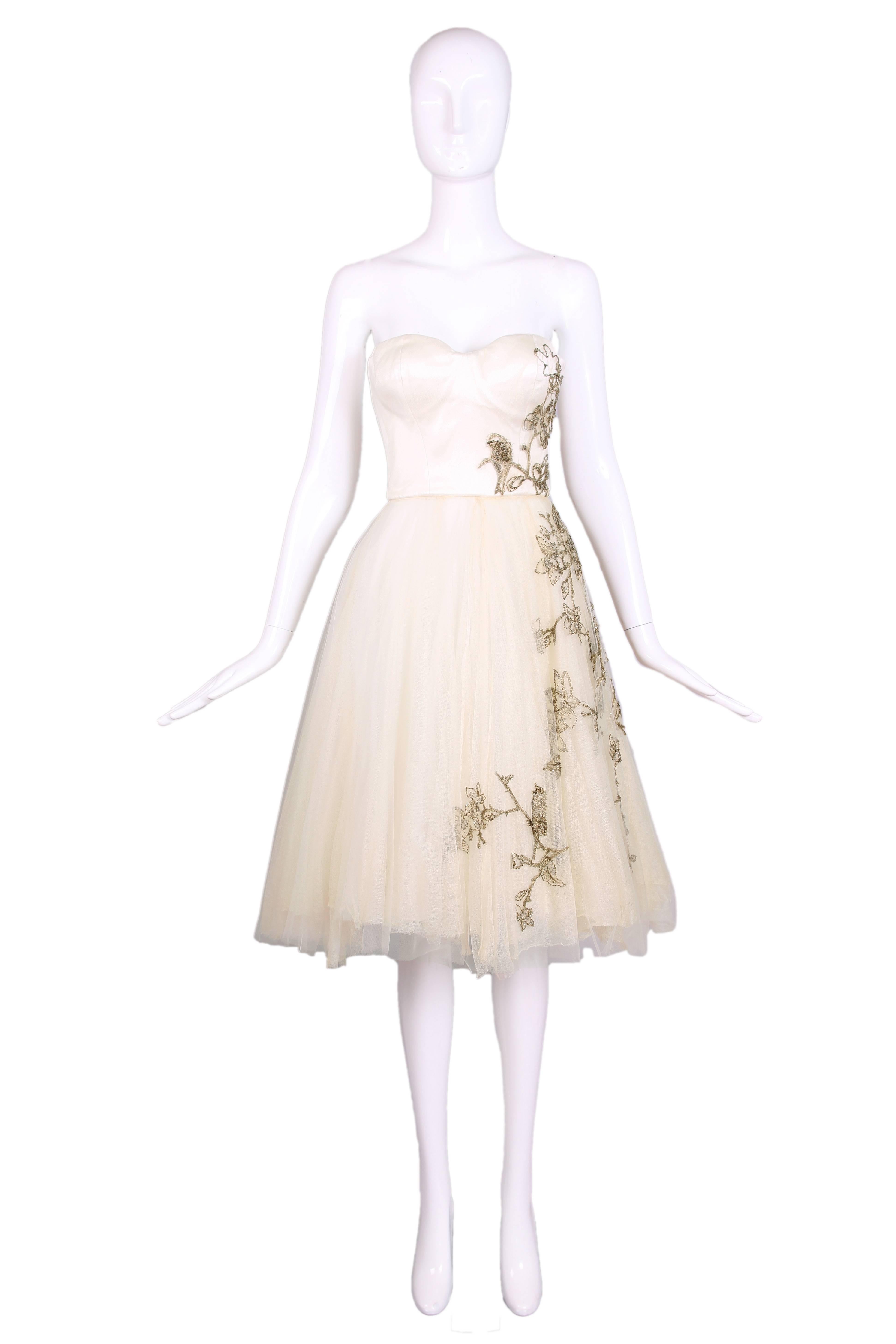 2008 F/W Alexander McQueen creme-colored strapless cocktail dress with an embroidered bird, branches and flower motif sewn out of gold and copper metallic thread and tiny copper sequins. The bodice is made of a silk satin with a single over layer of