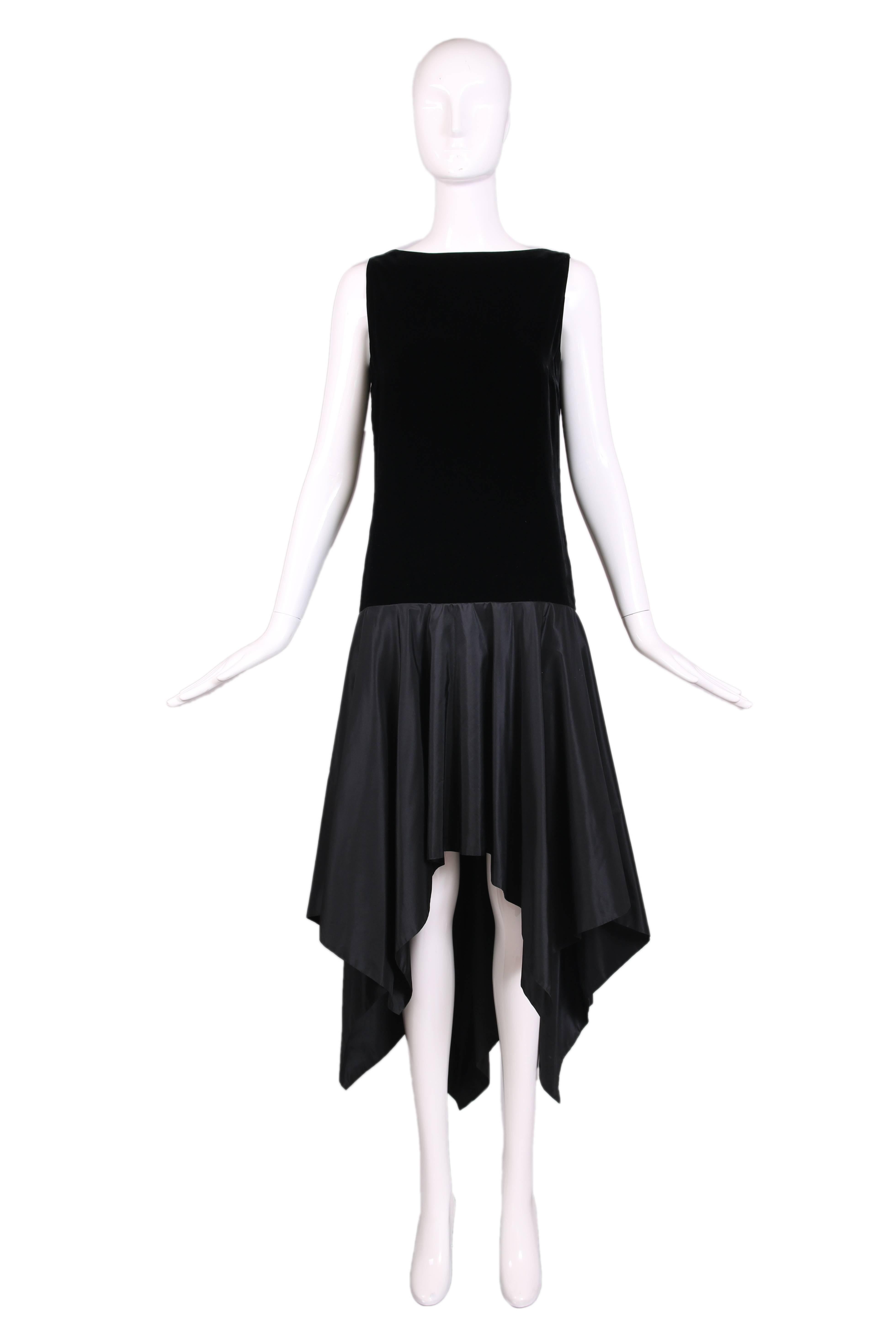 Ca. 1983 Lanvin haute couture black sleeveless cocktail dress featuring a velvet bodice with dropped waist with a deep V at bodice back and a silk taffeta skirt featuring a high-low, handkerchief hem. In excellent condition. 
MEASUREMENTS:
Bust -