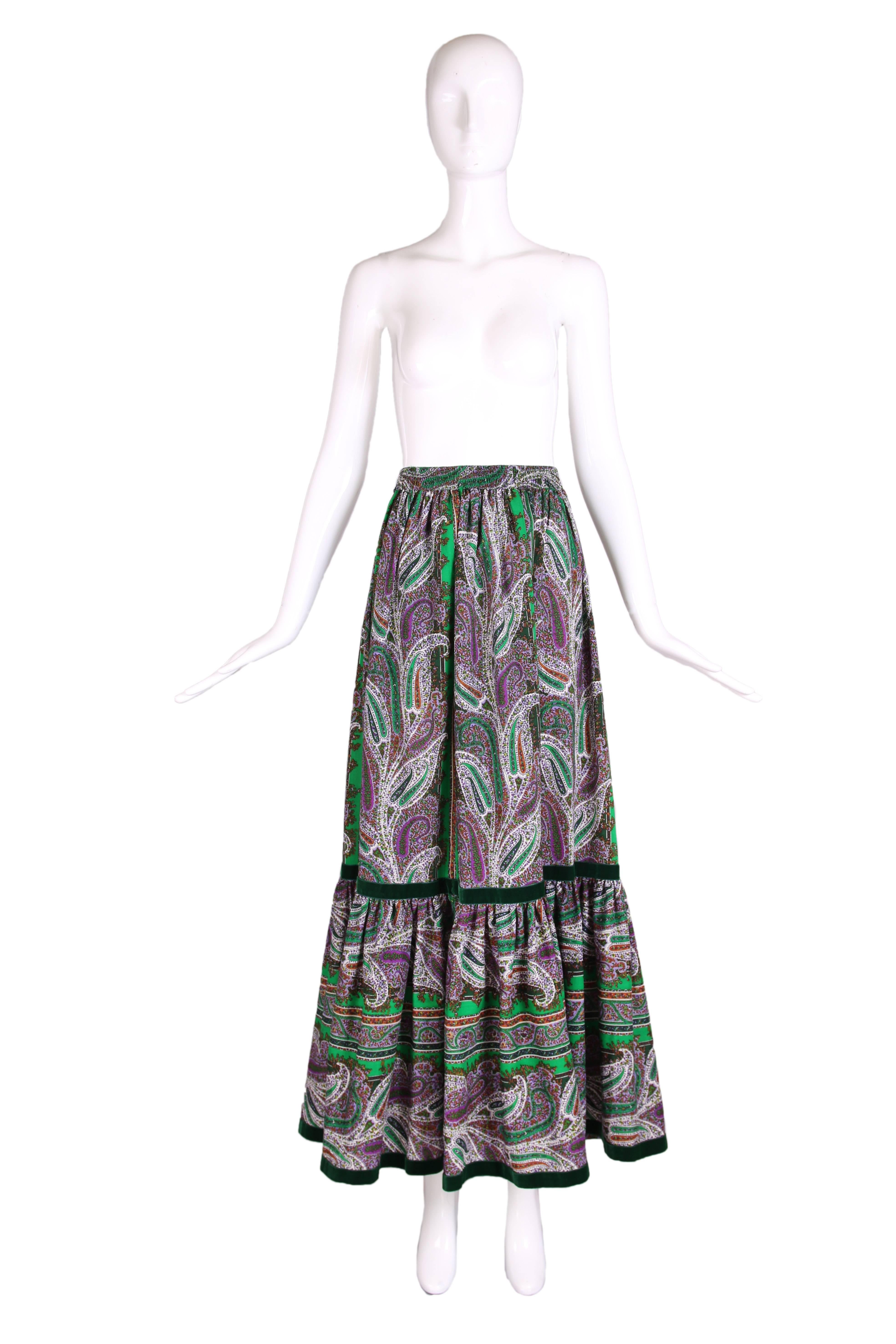 Vintage Yves Saint Laurent green, purple, red and black paisley print light weight wool maxi skirt in a peasant style with green velvet trim and an elastic waistband. Size 40. In excellent condition.
