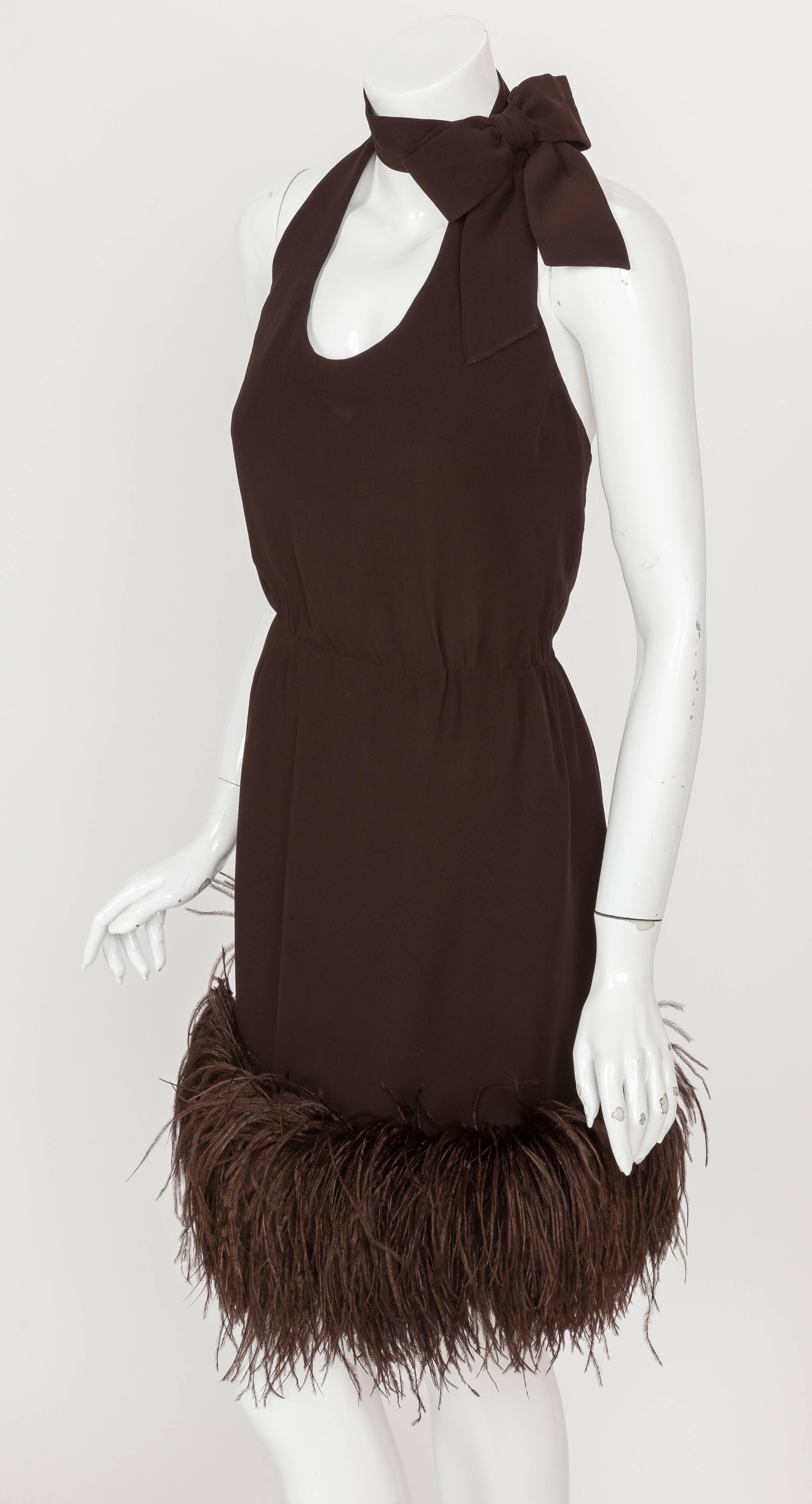 A mid-1960s Pierre Cardin haute couture brown chiffon halter dress with neck bow and Ostrich feather trim. Constructed from chocolate brown bias-cut silk chiffon, the cocktail dress features a wrap-around bow at the neck, an open back and Ostrich