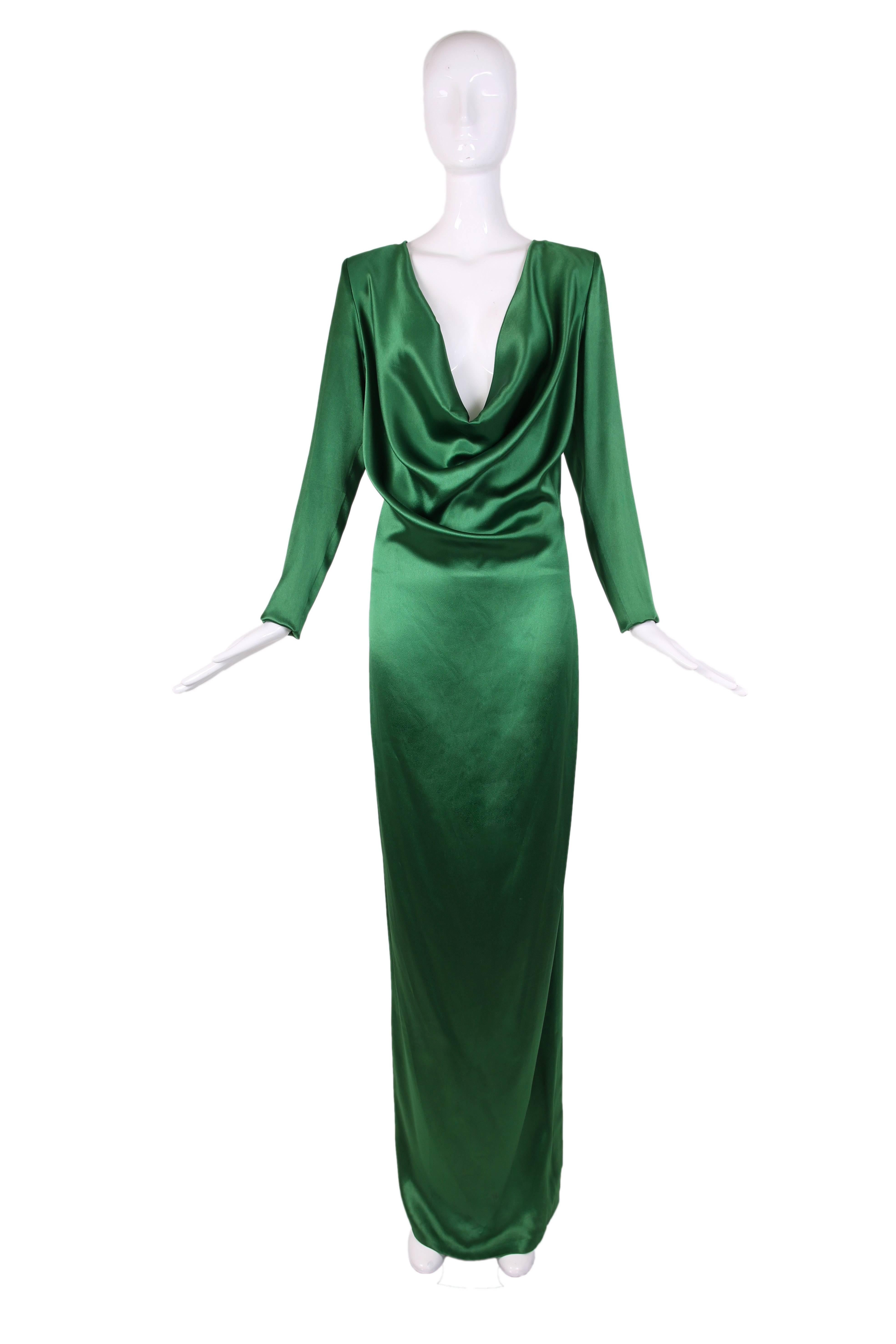 Emerald green satin long sleeved evening gown with dramatic cowl neckline & low cutout at back. There is a side zip closure as well as zipper at slight to create higher or lower slit on the leg. 