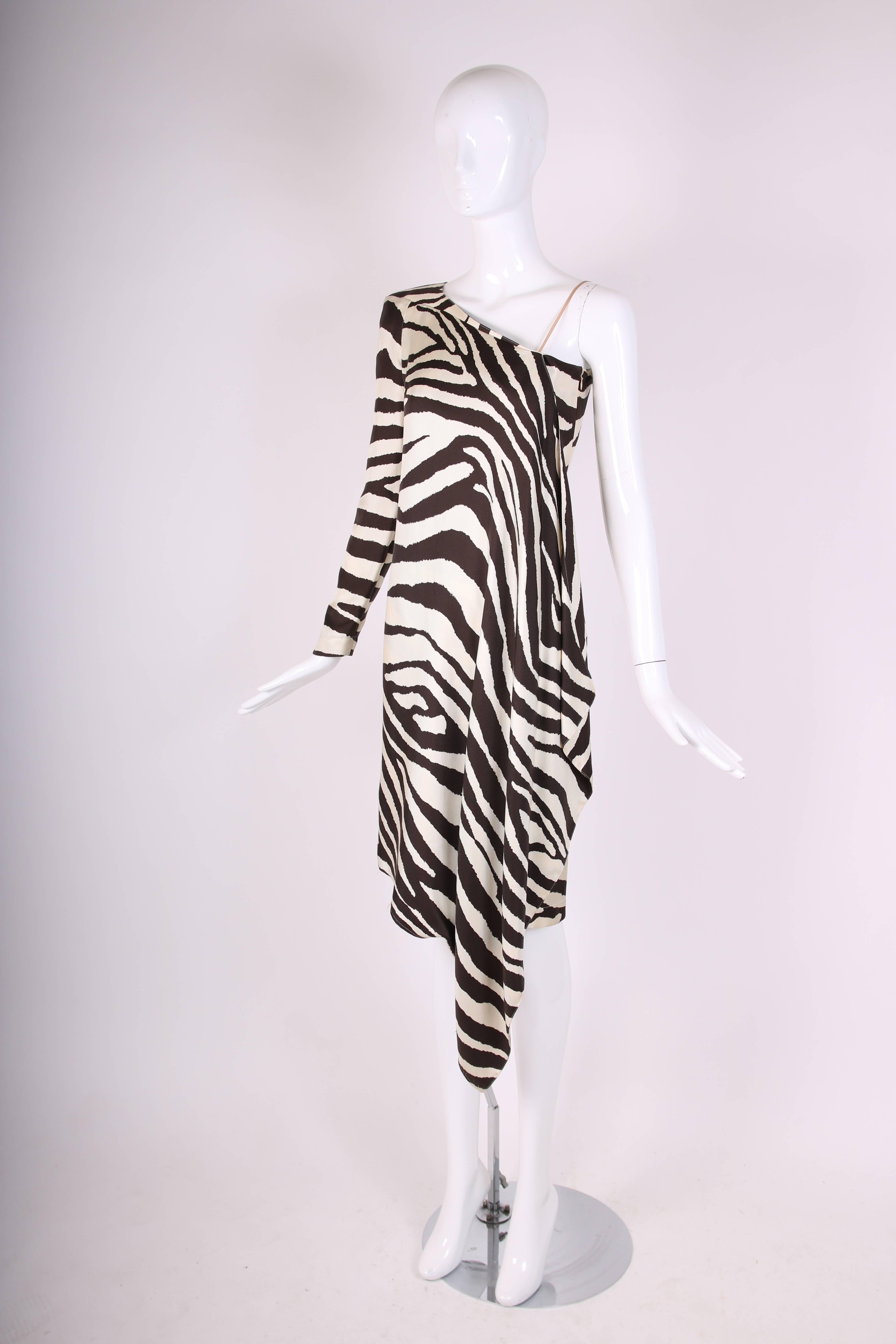 1998 Spring/Summer Thierry Mugler silk twill asymmetrical cocktail dress with iconic Mugler zebra print. This dress has one long sleeve with architectural shoulder and soft draping on the other. There is a side zip closure. Size tag 36.
Measurements