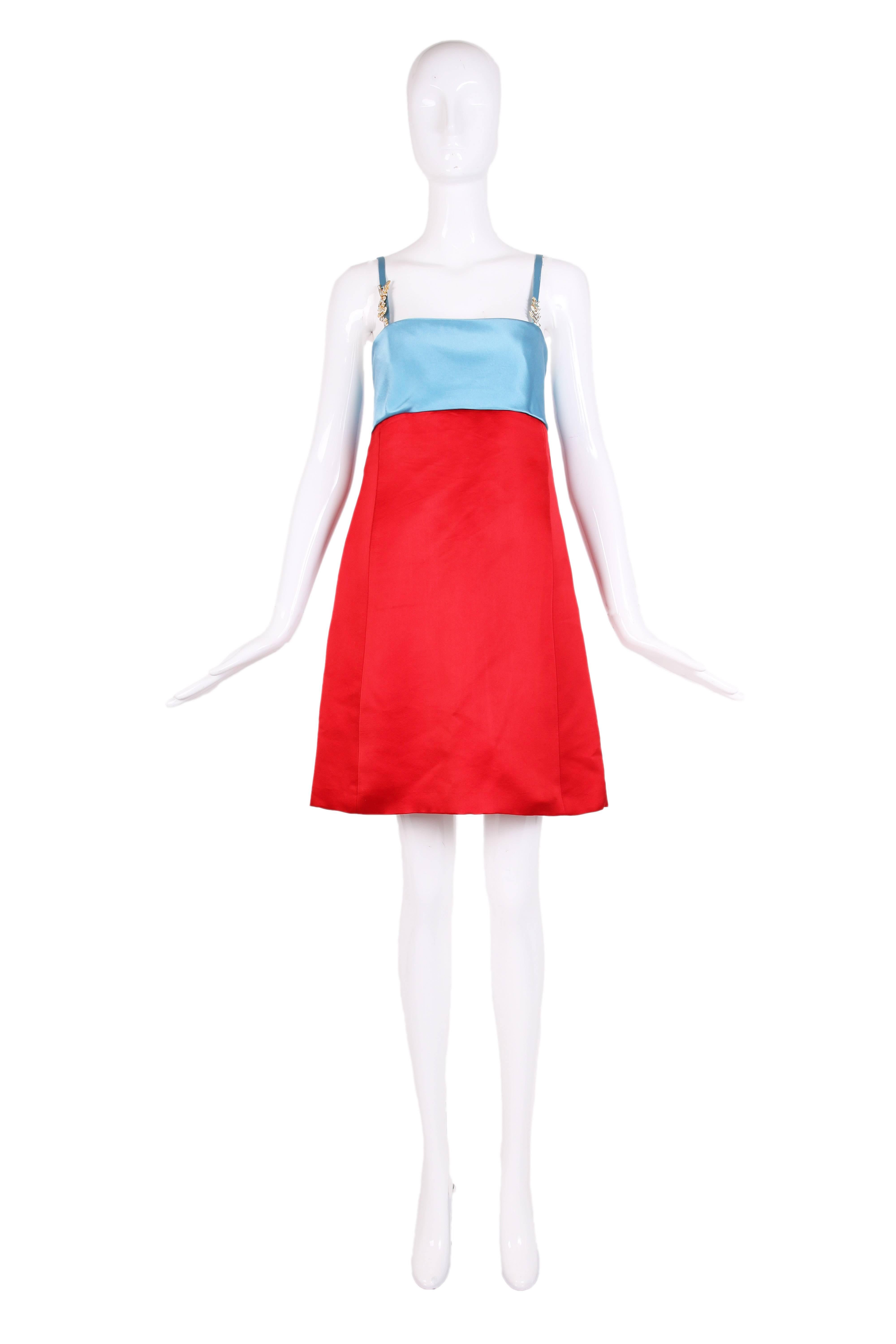 Vibrant crimson red and sky blue color block mini dress in duchess satin. The dress features a empire waist, spaghetti straps with rhinestone Versace & V embellishments on straps. Size tag 42.