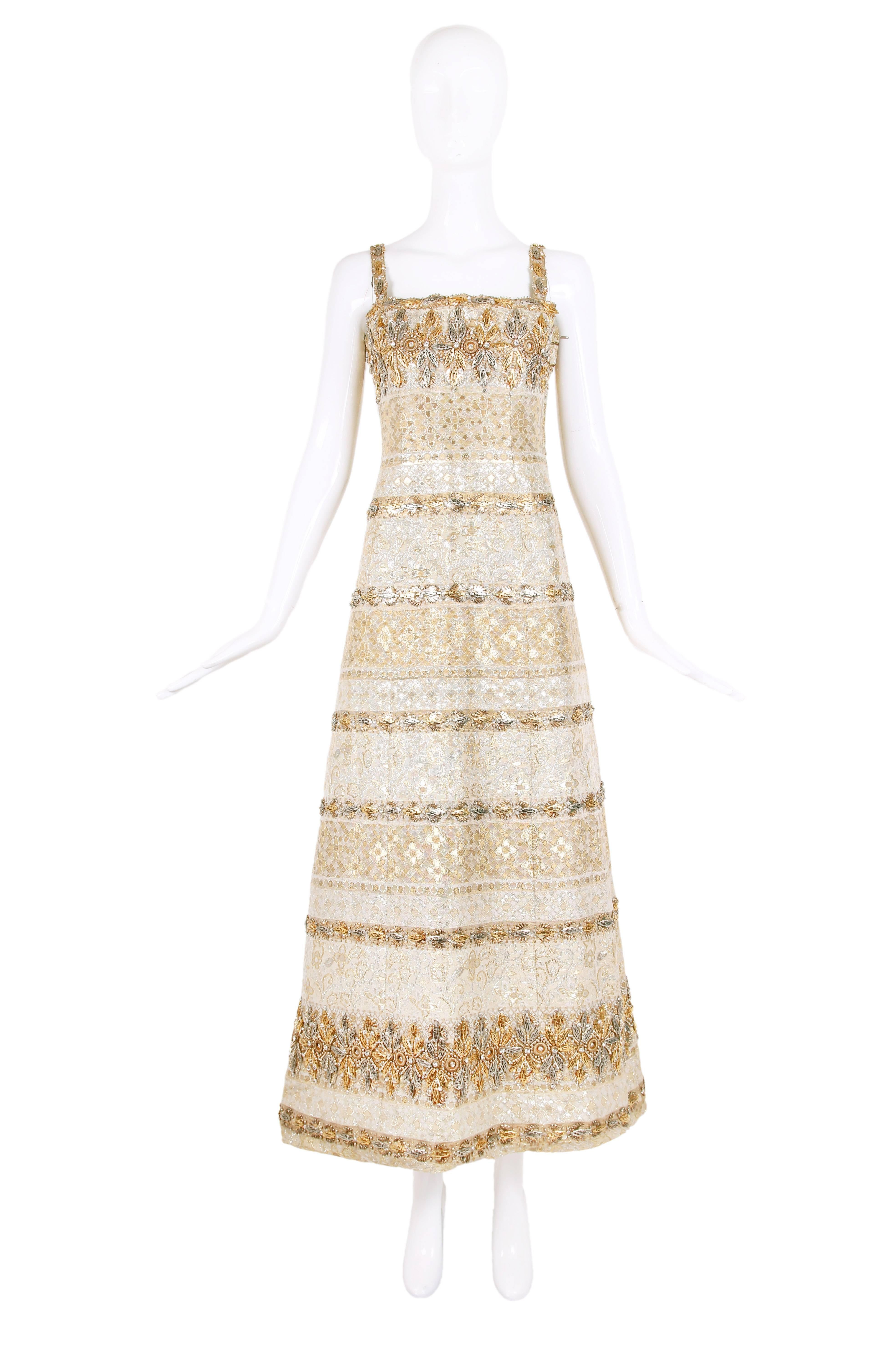 Circa 1966 Pierre Balmain haute couture evening gown in a gold and silver lurex brocade with elaborate embellishments. In excellent condition - some beads missing here and there. No size tag - please see measurements.
MEASUREMENTS:
Bust -