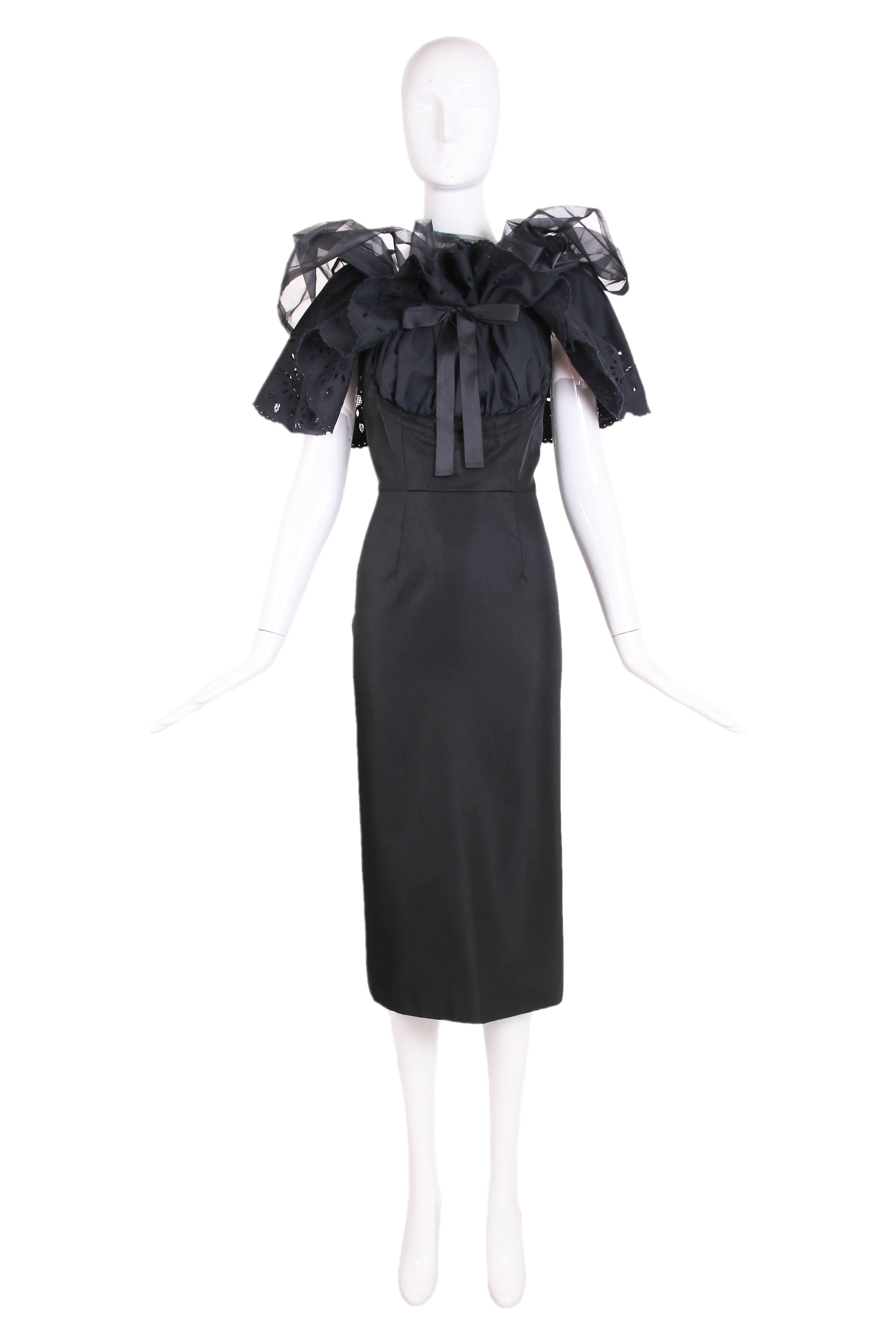 2001 Comme Des Garcons black sleeveless shift dress with exaggerated collar comprising a layer of cotton eyelet lace and sheer nylon that continues below the waistline and is gathered at center from with attached ties. This piece is in excellent