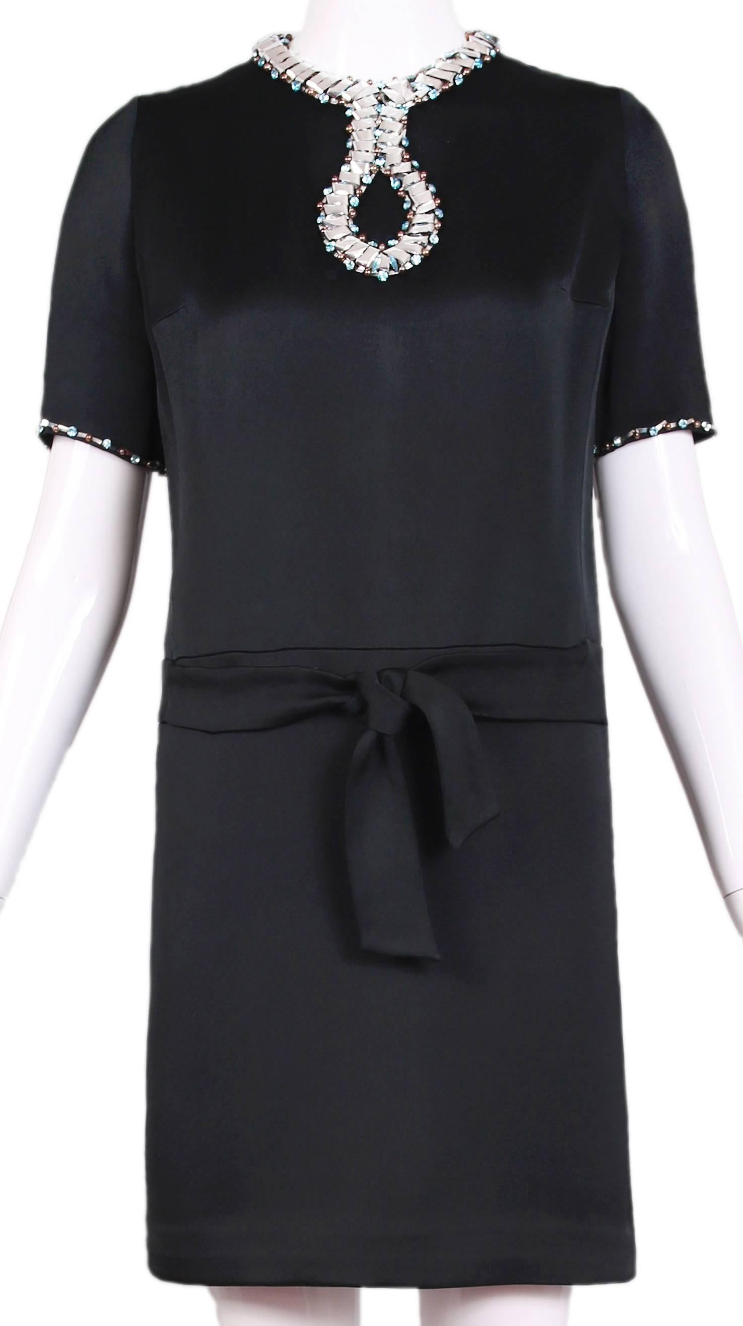 Ca.1966 Pierre Cardin haute couture black silk mini short-sleeved cocktail dress with silver foil, blue jewels and brown beaded trim at neckline, bust and edge of sleeve. Features a slightly dropped waist and inset belt detail. Zip closure at center