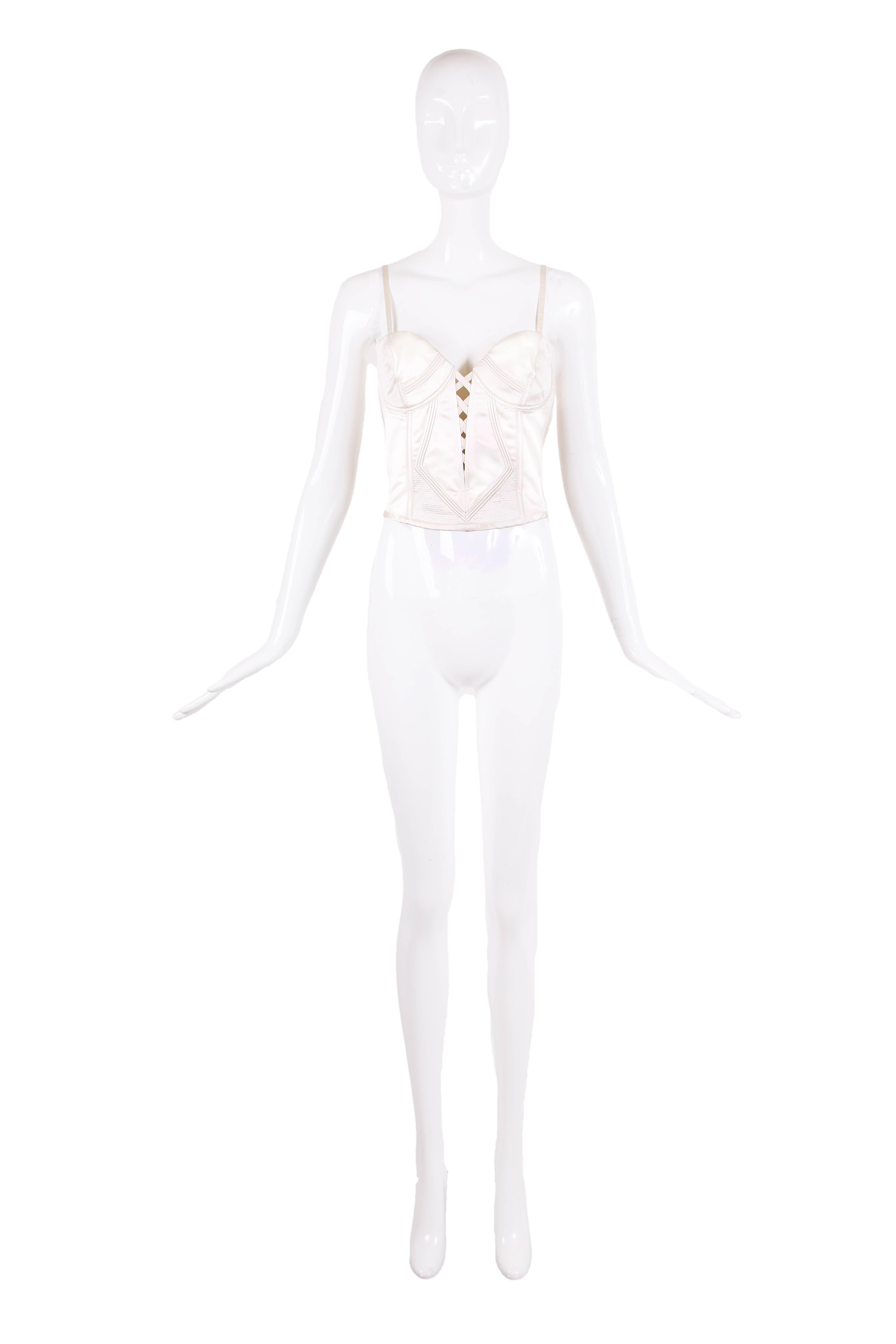 1995 Gianni Versace with Bergdorf Goodman label ivory satin bustier with overstitching and trapunto detailing at front and back. Details include hidden side zipper closure, interior boning and lace up design at front. In excellent condition -