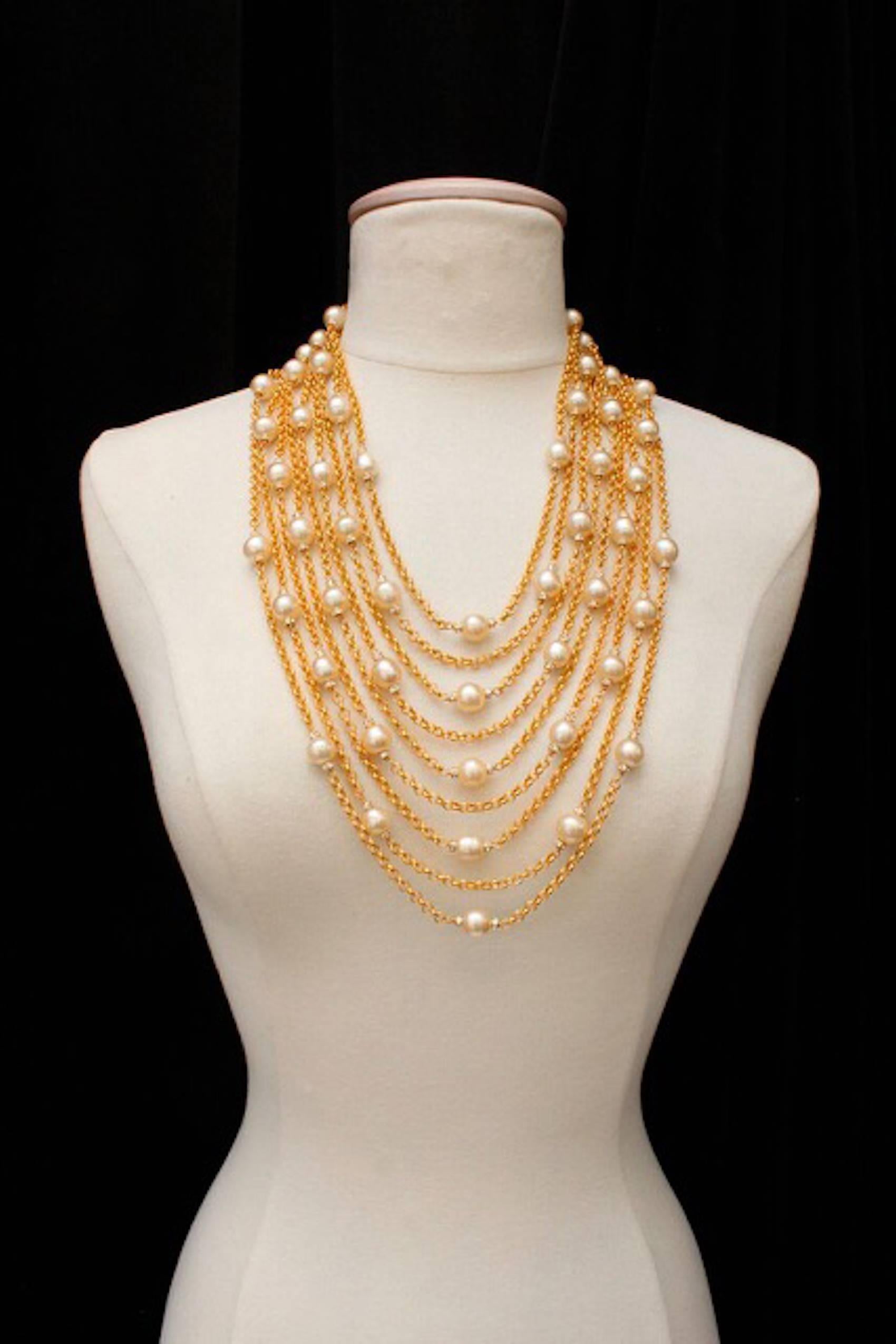 Vintage Chanel 9-stranded gold tone rolo chain, pearl and crystal encrusted rondelle necklace. In excellent condition - stamped Chanel.
shortest drop - 11"
longest - 15" 