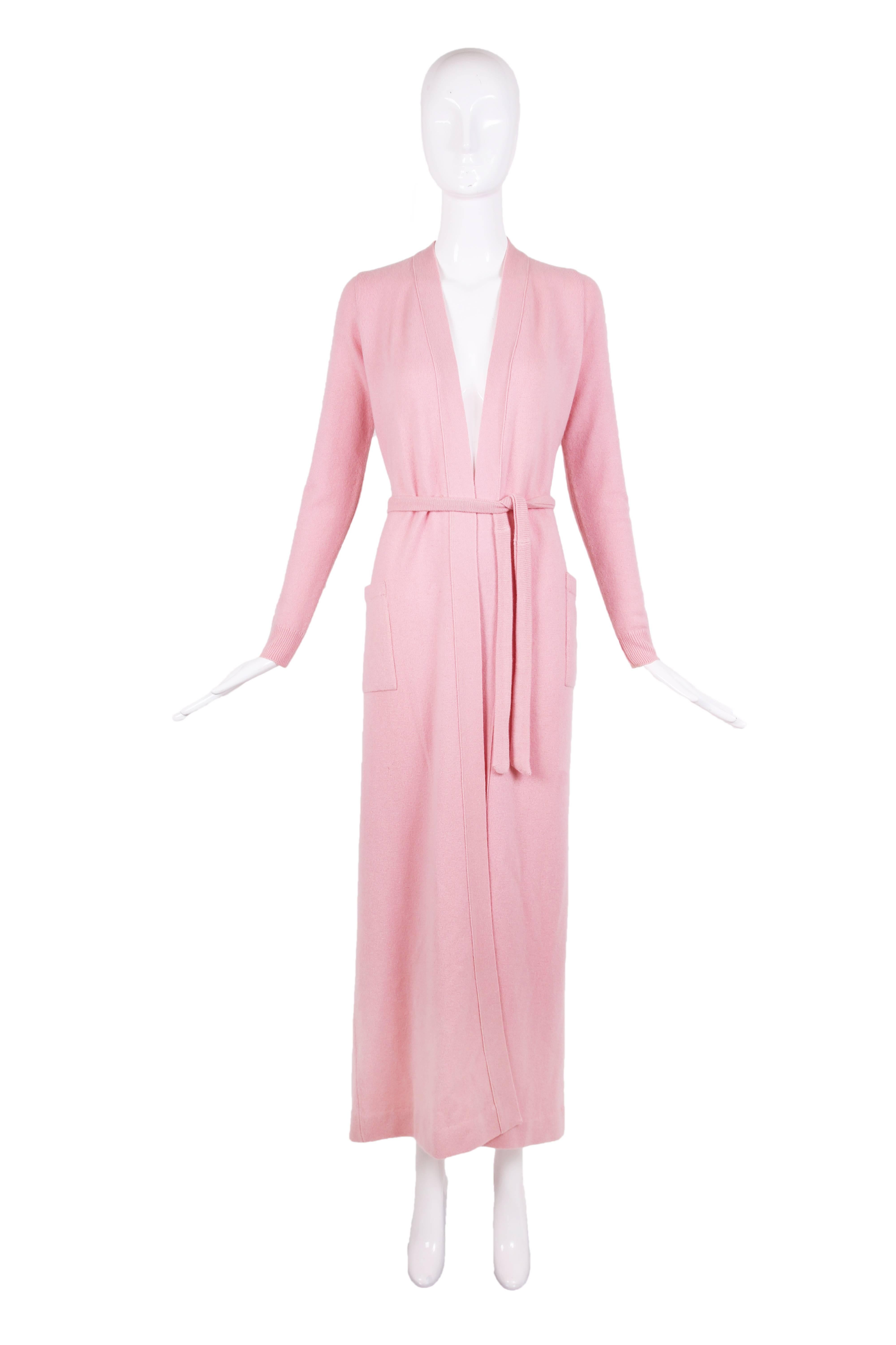 1970's Halston baby pink cashmere floor length cardigan with detachable self belt. In excellent condition with two nearly imperceptible repairs.
MEASUREMENTS:
Shoulders - 13