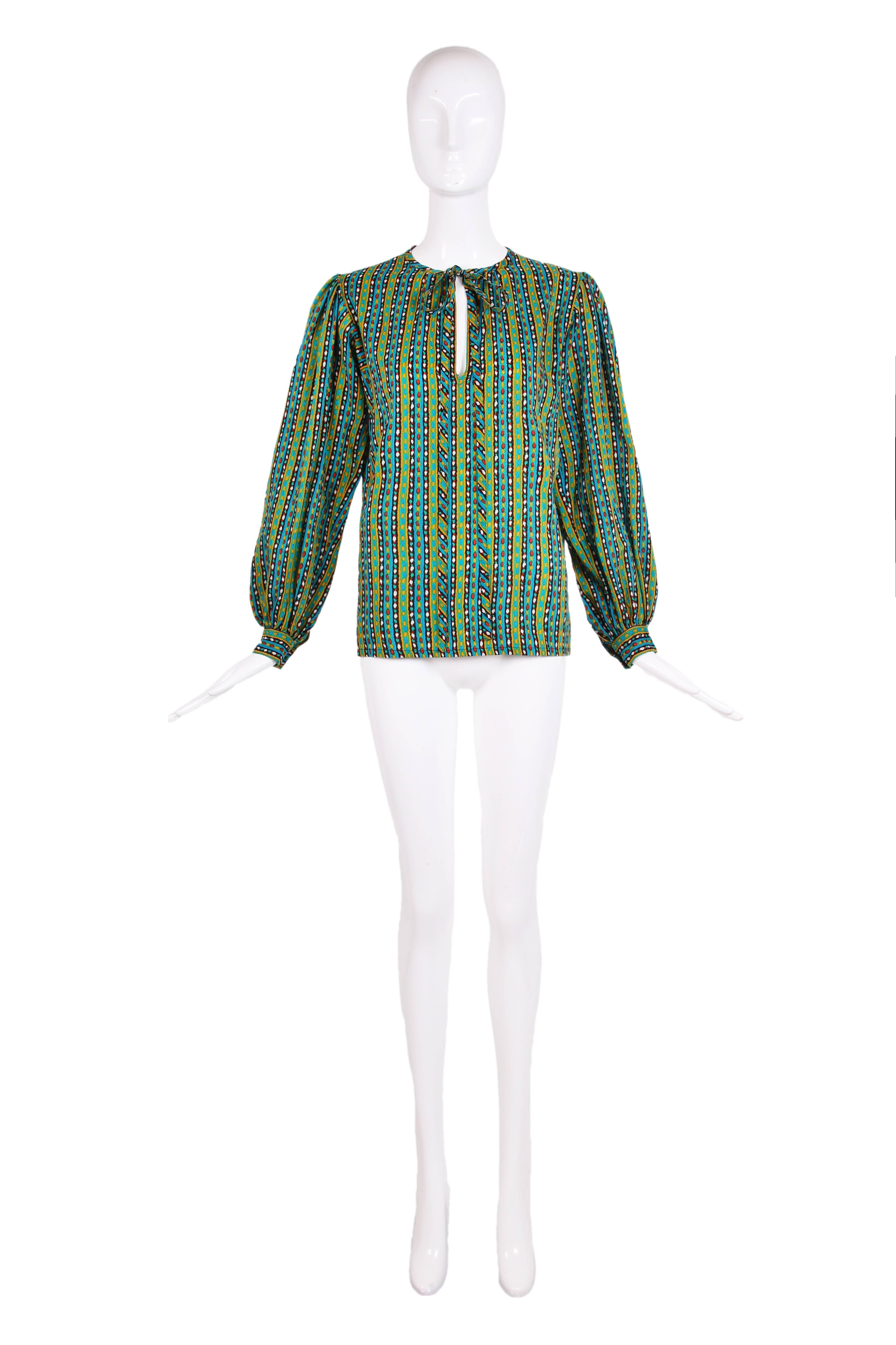 1970's Yves Saint Laurent lightweight wool printed blouse with full sleeves and long ties at the neck. In excellent condition - size tag 38, please consult measurements.
MEASUREMENTS:
Shoulders - 15"
Sleeves - 23"
Bust - 40"
Waist -