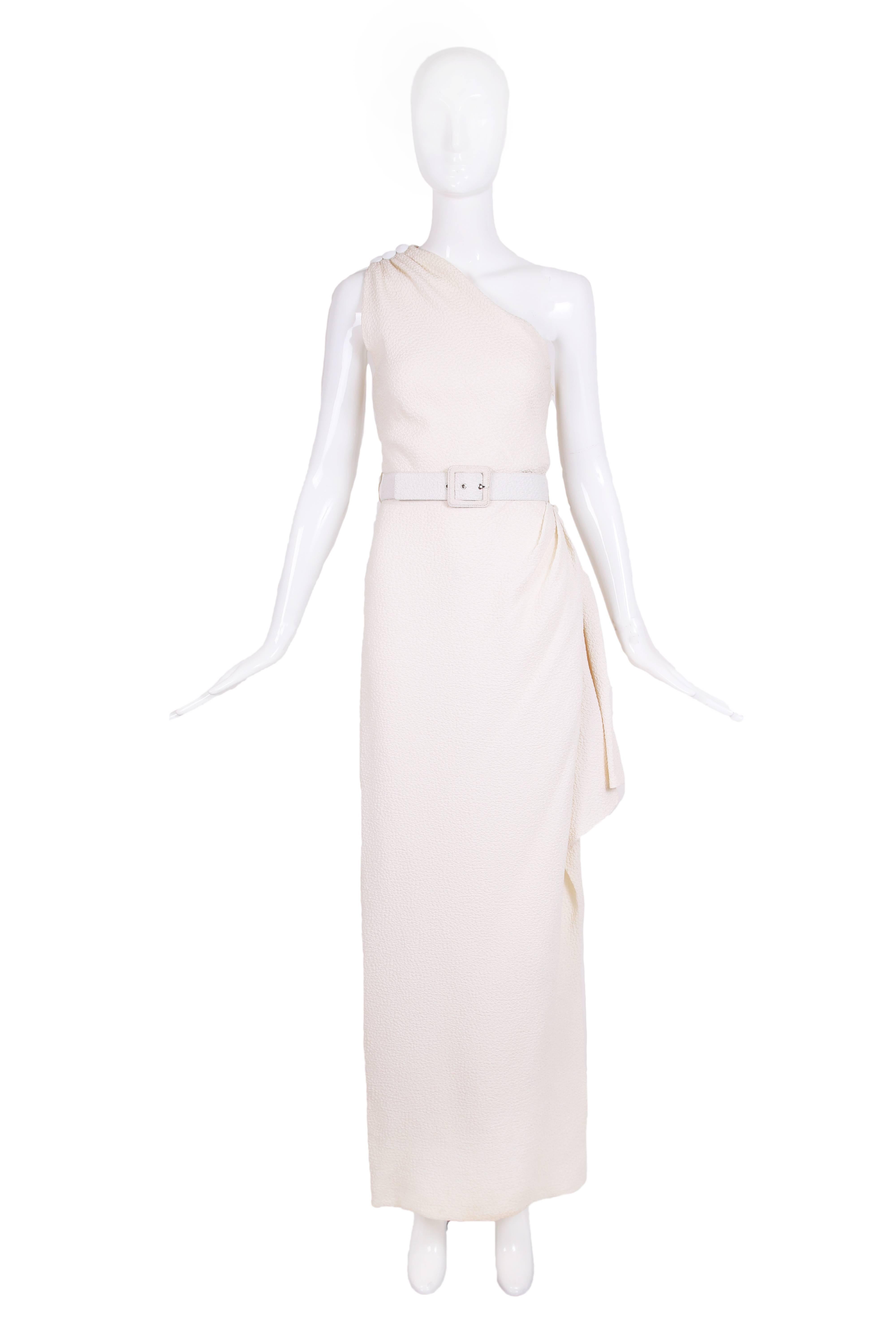Vintage Yves Saint Laurent ivory puckered silk single shoulder gown with side ruffle detail, thigh-high slit and belt. Size 40. In very good condition with two chips at the center button of the shoulder closure.
MEASUREMENTS:
Bust - 36