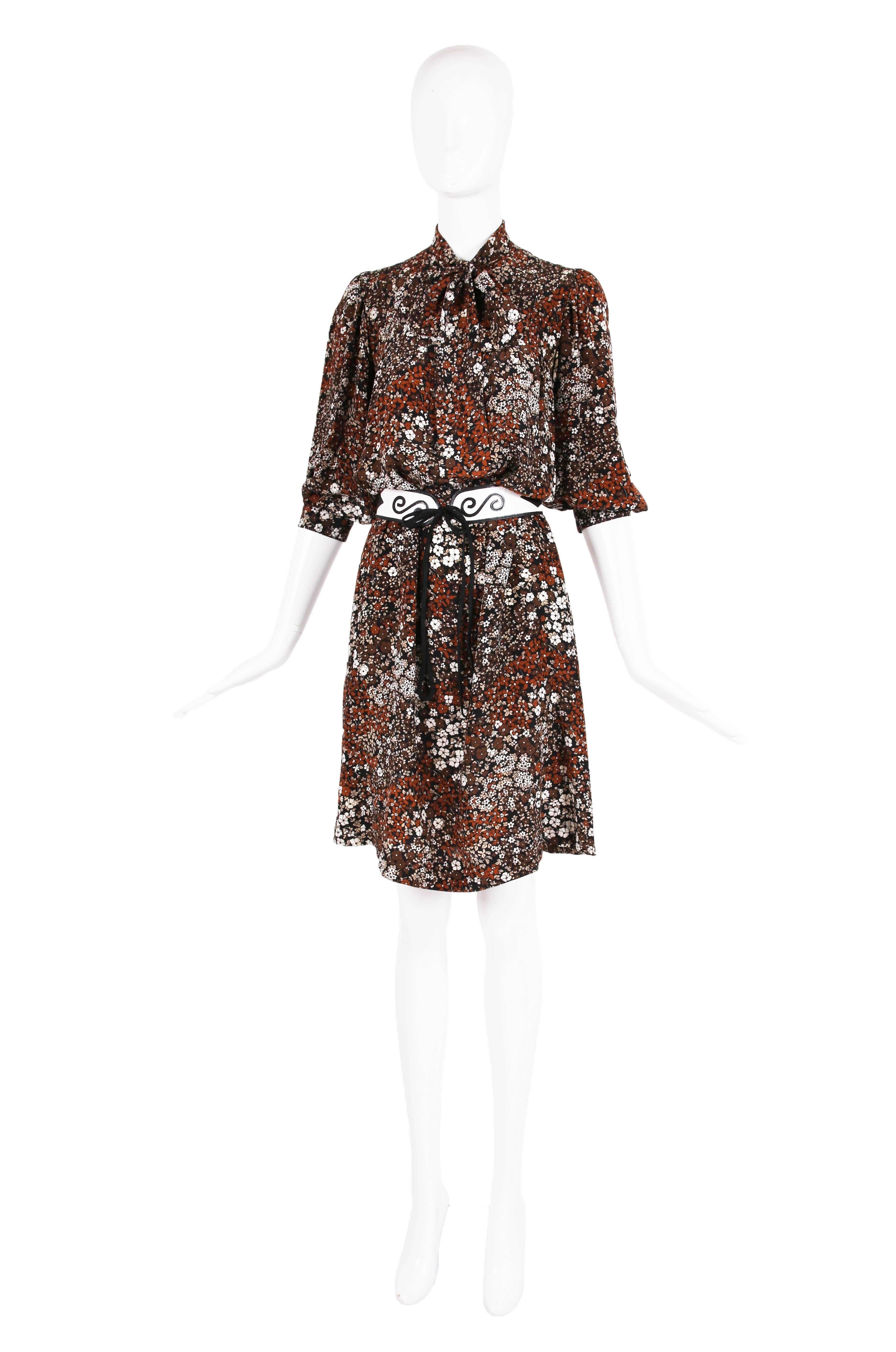 Yves Saint Laurent 1970's abstract floral 100% silk day dress in shades of brown, beige and white with pin-tucking detail at upper bodice, two frontal neck ties that tie in a bow, hidden side pockets, 3/4 sleeves and button closure at center front