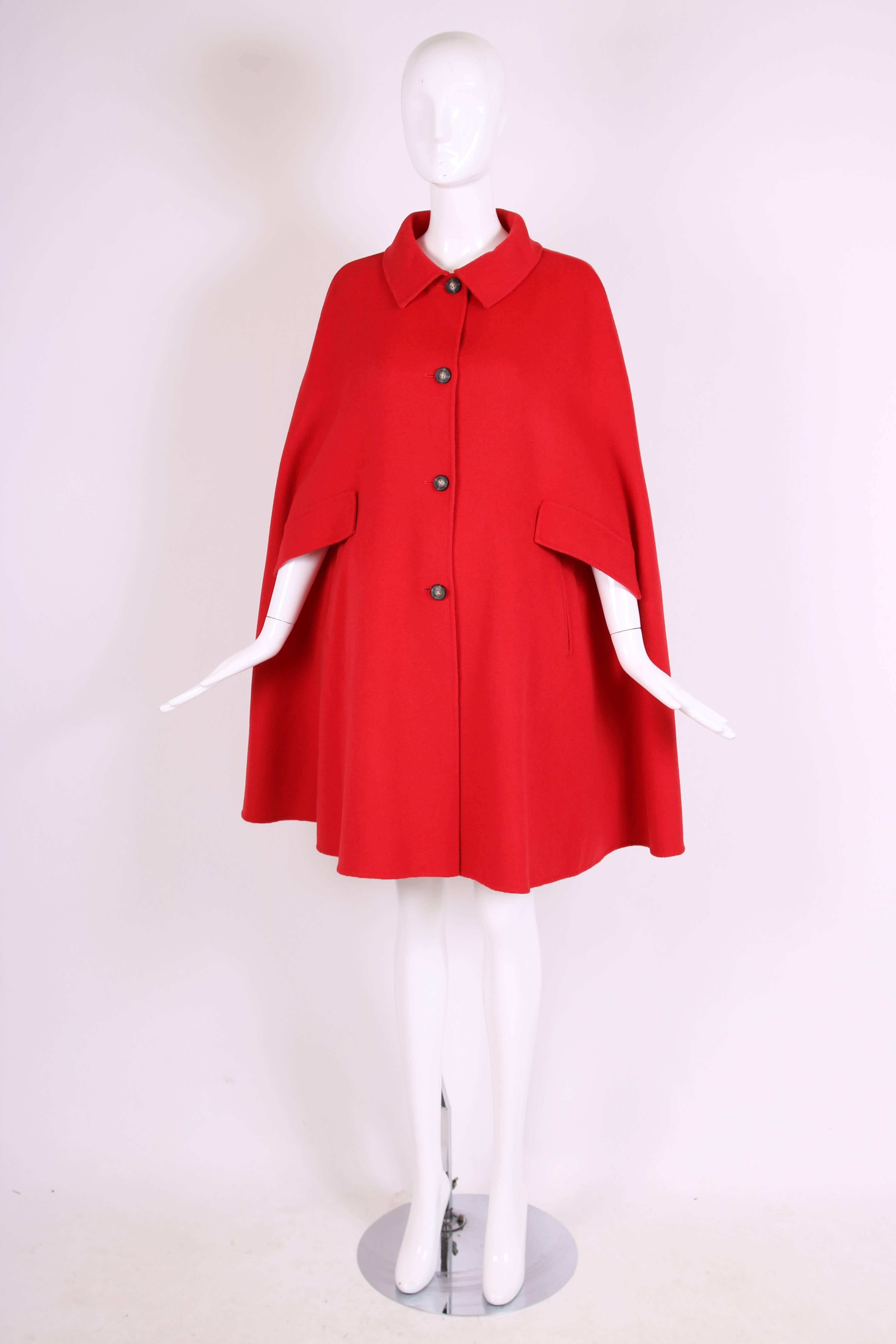 Armani Collezioni red wool angora blend cape with opening for arms and frontal pockets. Size 42. In excellent condition.
MEASUREMENTS:
Length - 37"