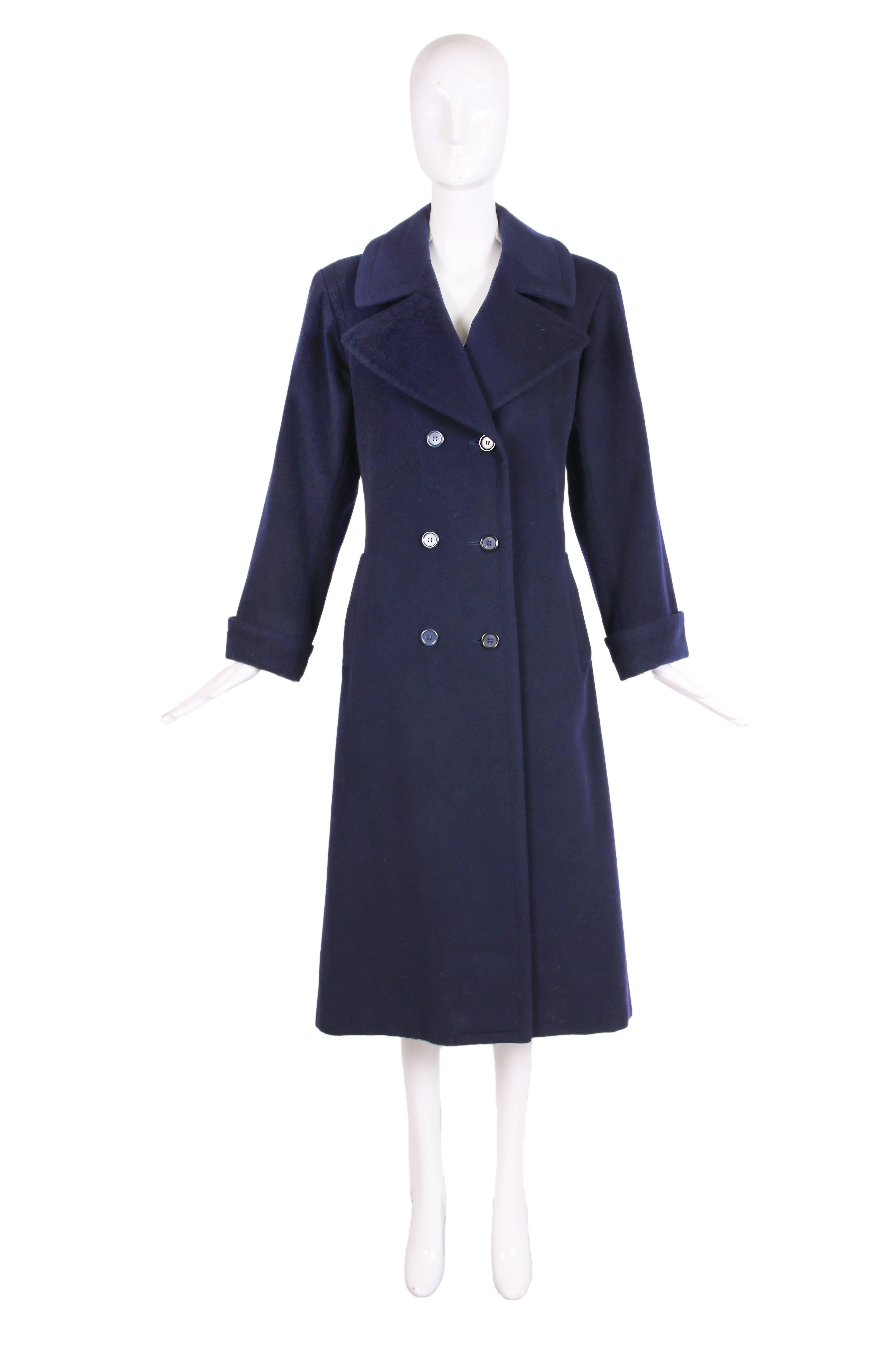 Vintage Yves Saint Laurent navy blue wool double breasted coat with frontal pockets, rolled sleeves, back vent at hem and buttoned bar element at back waist. Fully lined, size tag 38 - in excellent condition. Please see measurements - this appears