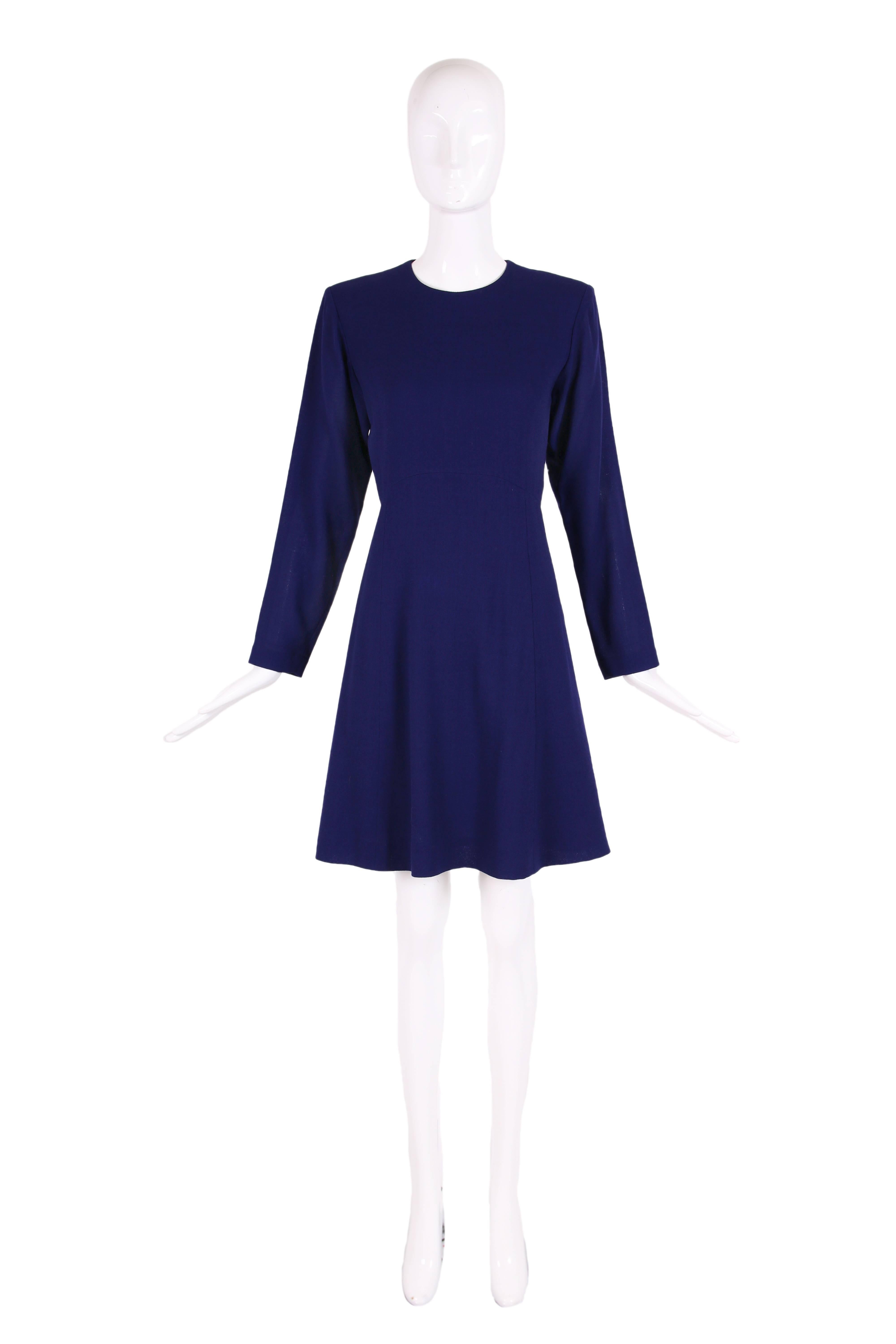 1990's Yves Saint Laurent deep purple day dress in a lightweight wool and slightly flared skirt. Hidden zipper up center back. Size tag 38. In excellent condition two tiny holes in the fabric just under the right sleeve - impossible to see unless