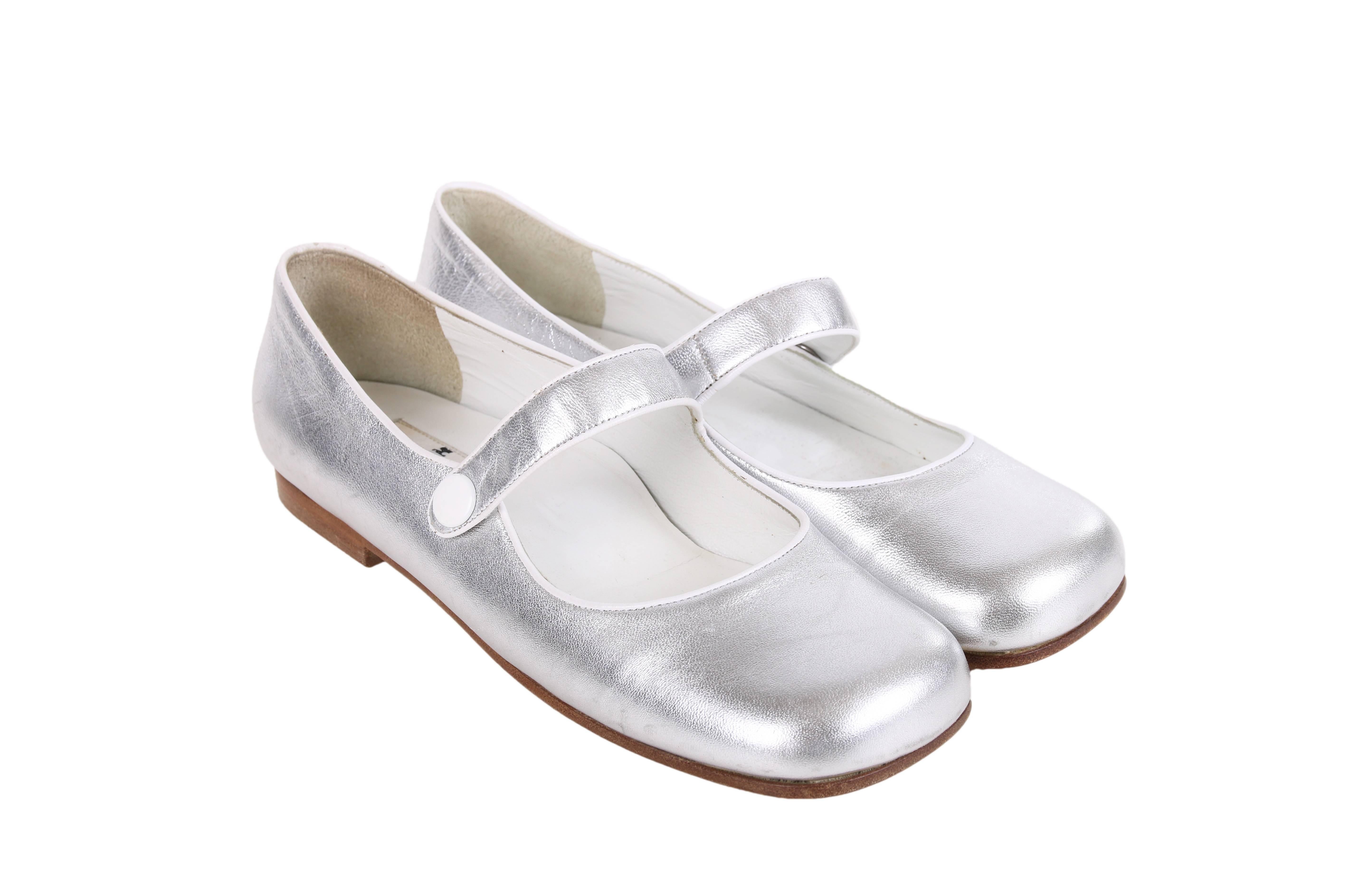 Circa 2010 Courreges silver leather Mary Janes with a square toe, white piping trim and a round white metallic snap closure at the side strap. In excellent condition -  appear to have never been worn. Size 37.