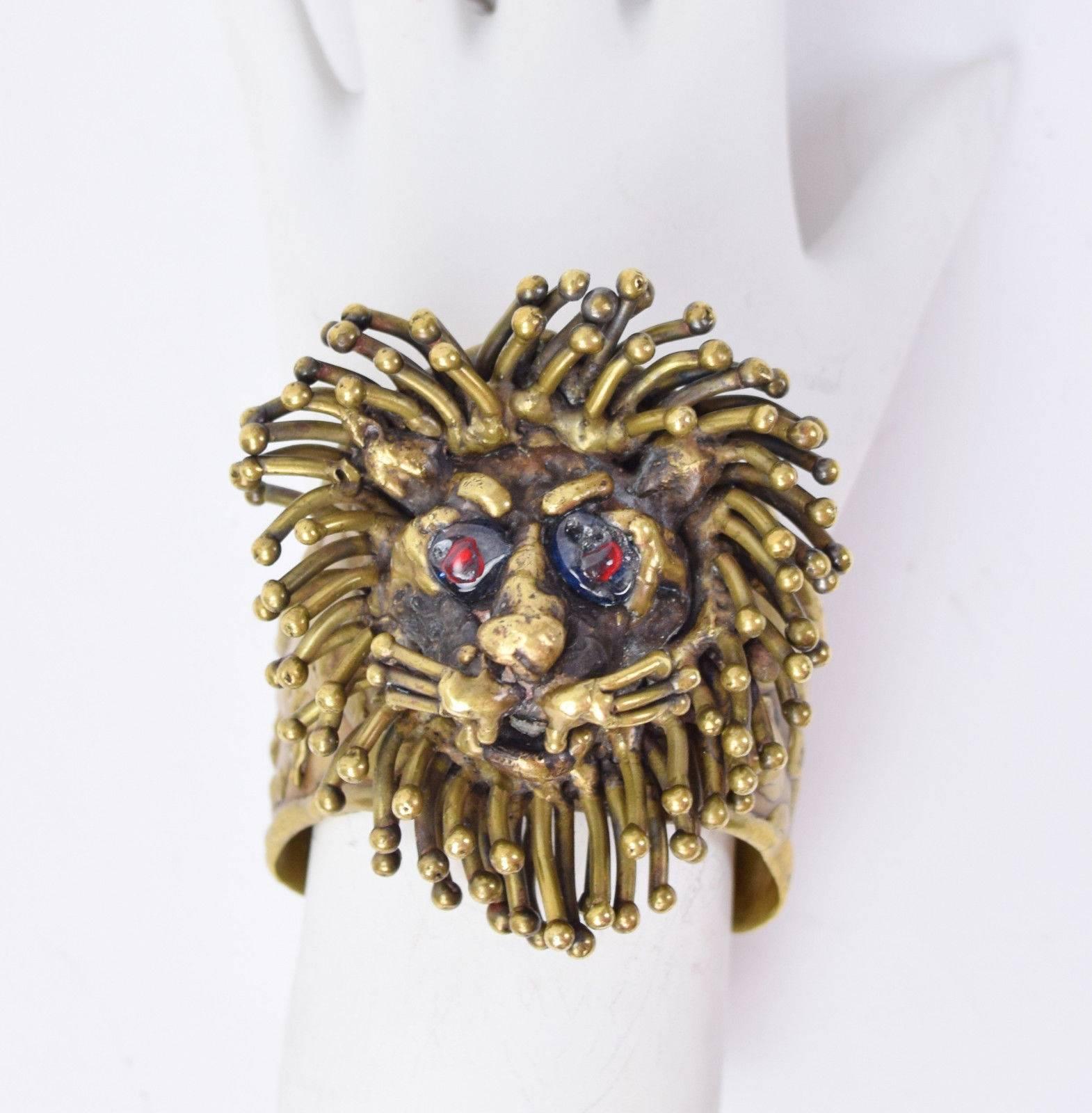 1970's Pal Kepenyes lion head cuff gilt bronze with artist poured molten glass eyes, and natural patina. Signed inside the cuff “Pal Kepenyes Mexico”. Measures overall 2.5in width x 2.75in height. Measures 2 1/8" across the inside opening by