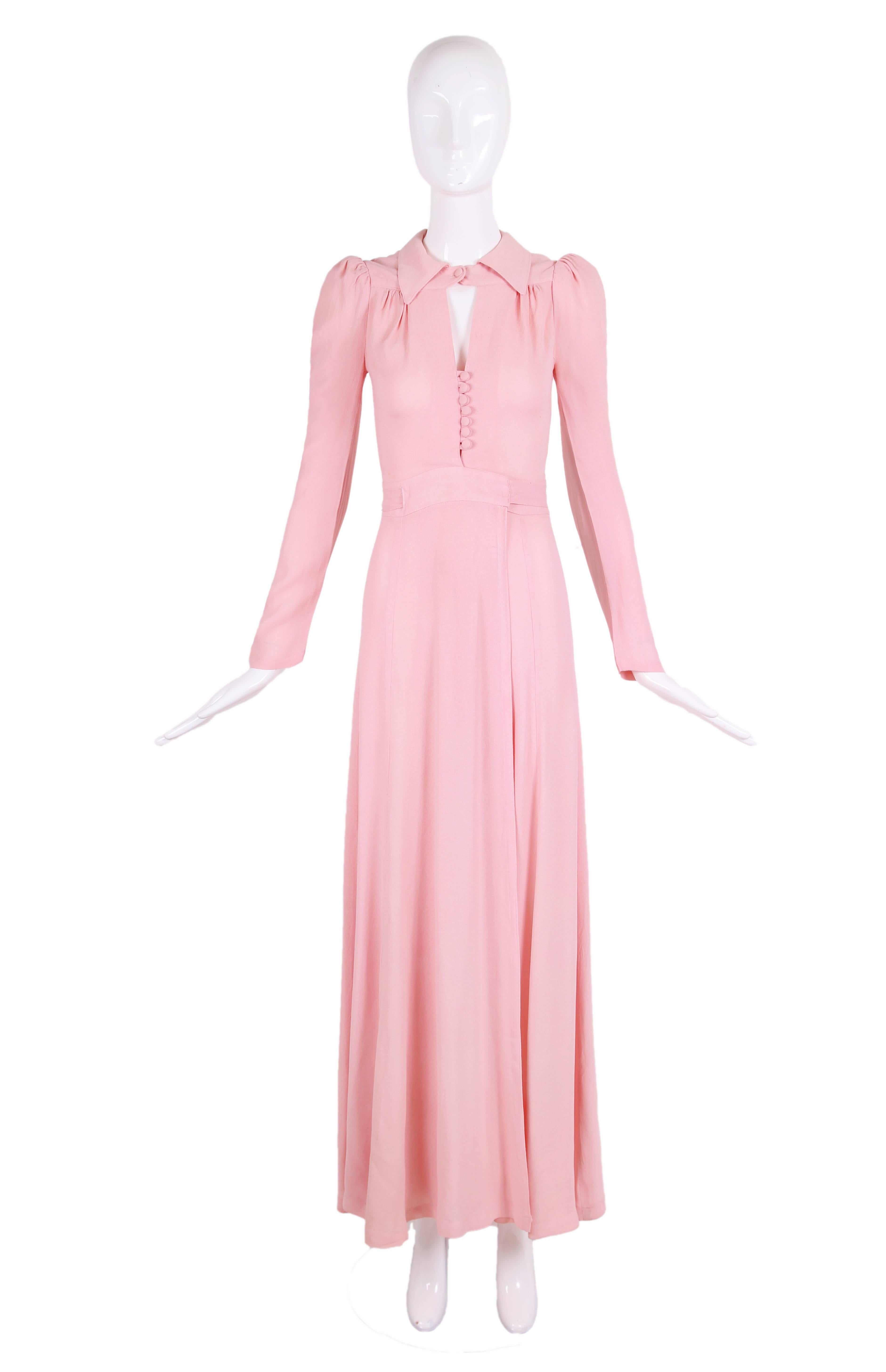 1970's Ossie Clark for Radley pink moss crepe maxi dress featuring a wrap skirt with extra long waist ties, a collared neckline with keyhole opening detail, fabric-covered buttons and a slight puffed sleeve. In very good condition with some