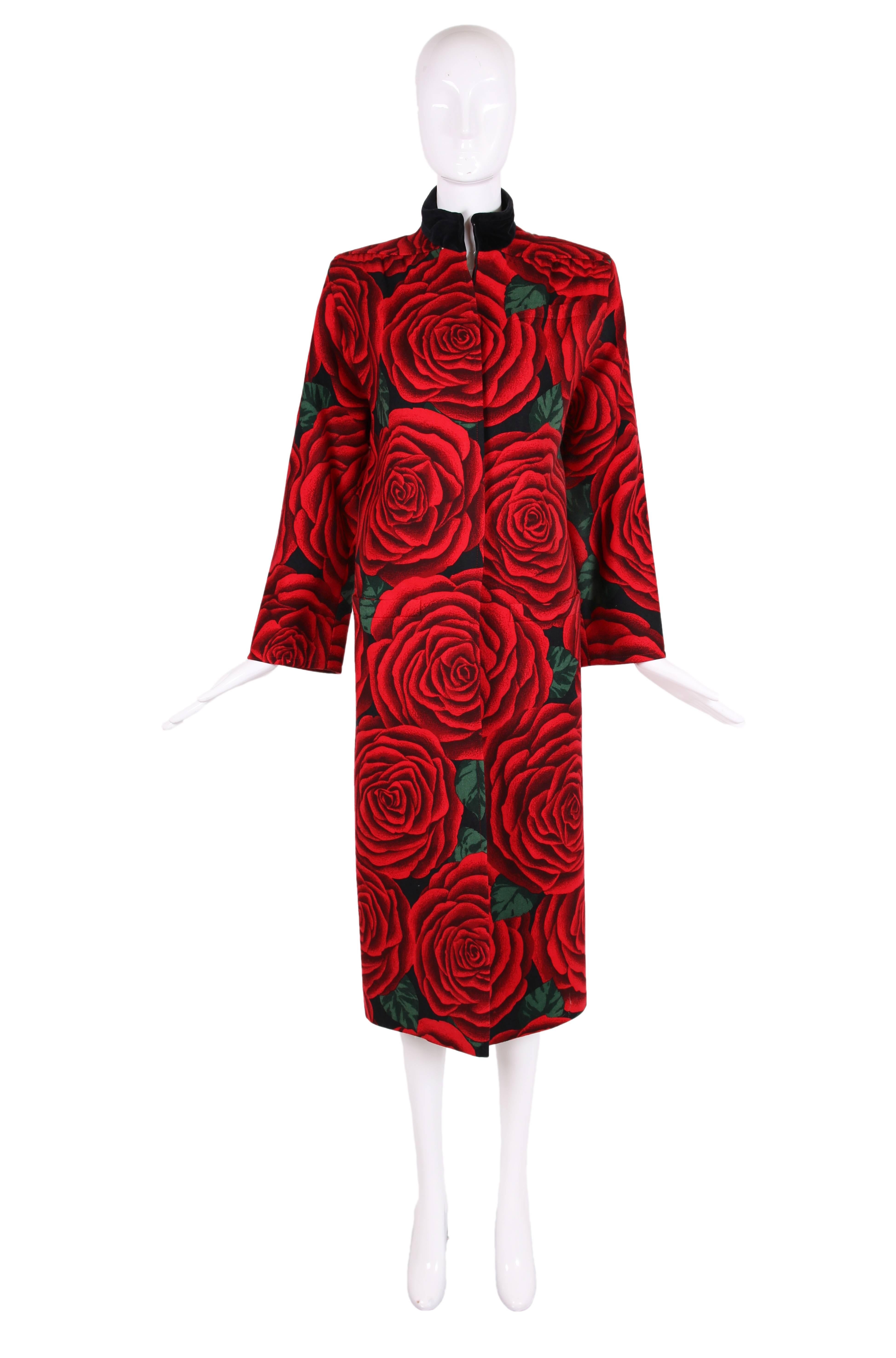 Vintage Valentino wool coat with red, black and green print featuring oversized cabbage rose print. Features zipper up center front, three frontal pockets, black velvet collar, quilted silk interior lining and oversized shoulders. In excellent