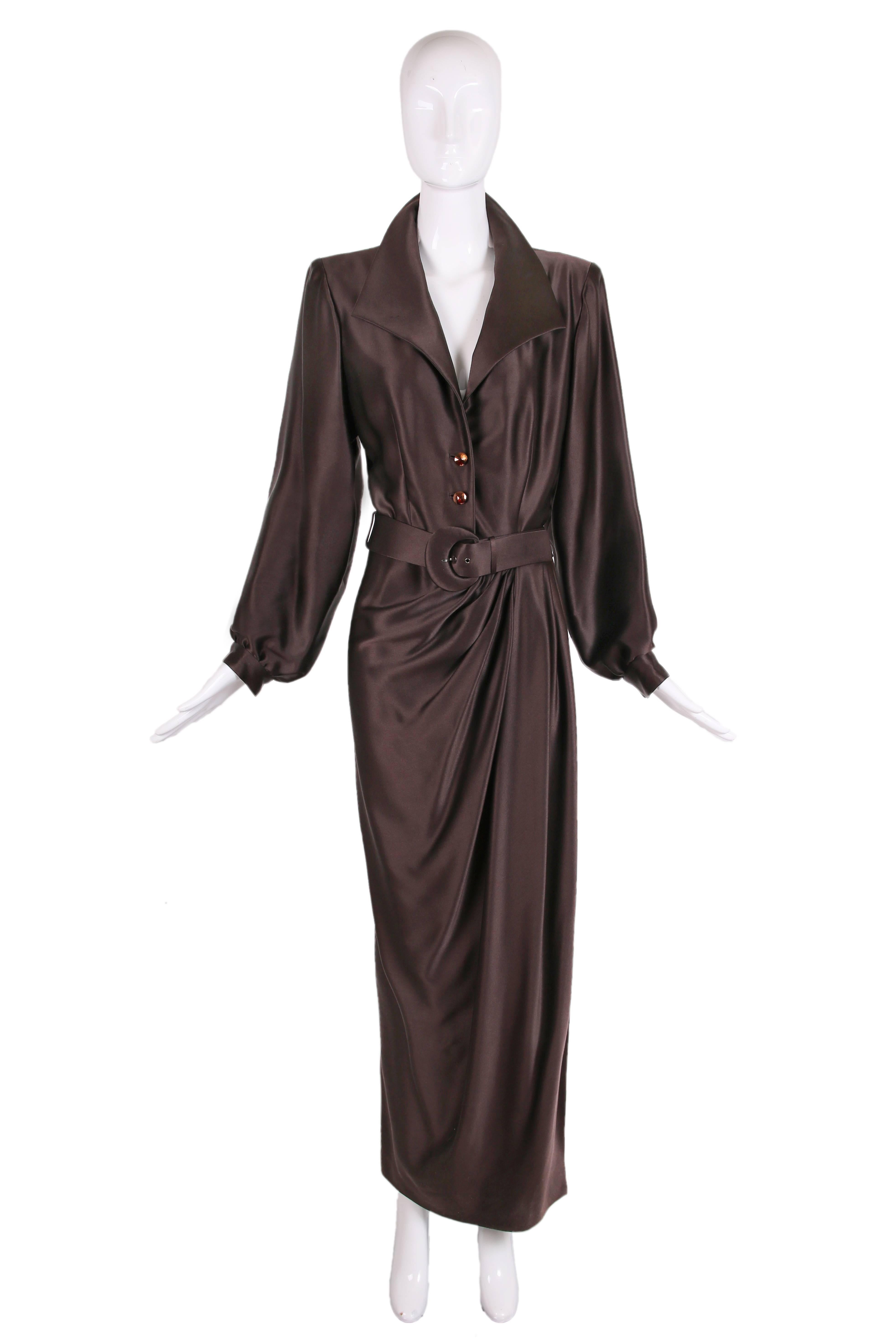 1989 Yves Saint Laurent haute couture brown silk collared evening gown with deep V-neck opening, faceted faux copper button closures at bodice and wrap skirt with gathers that drape diagonally across the skirt. Has shoulder pads which can be