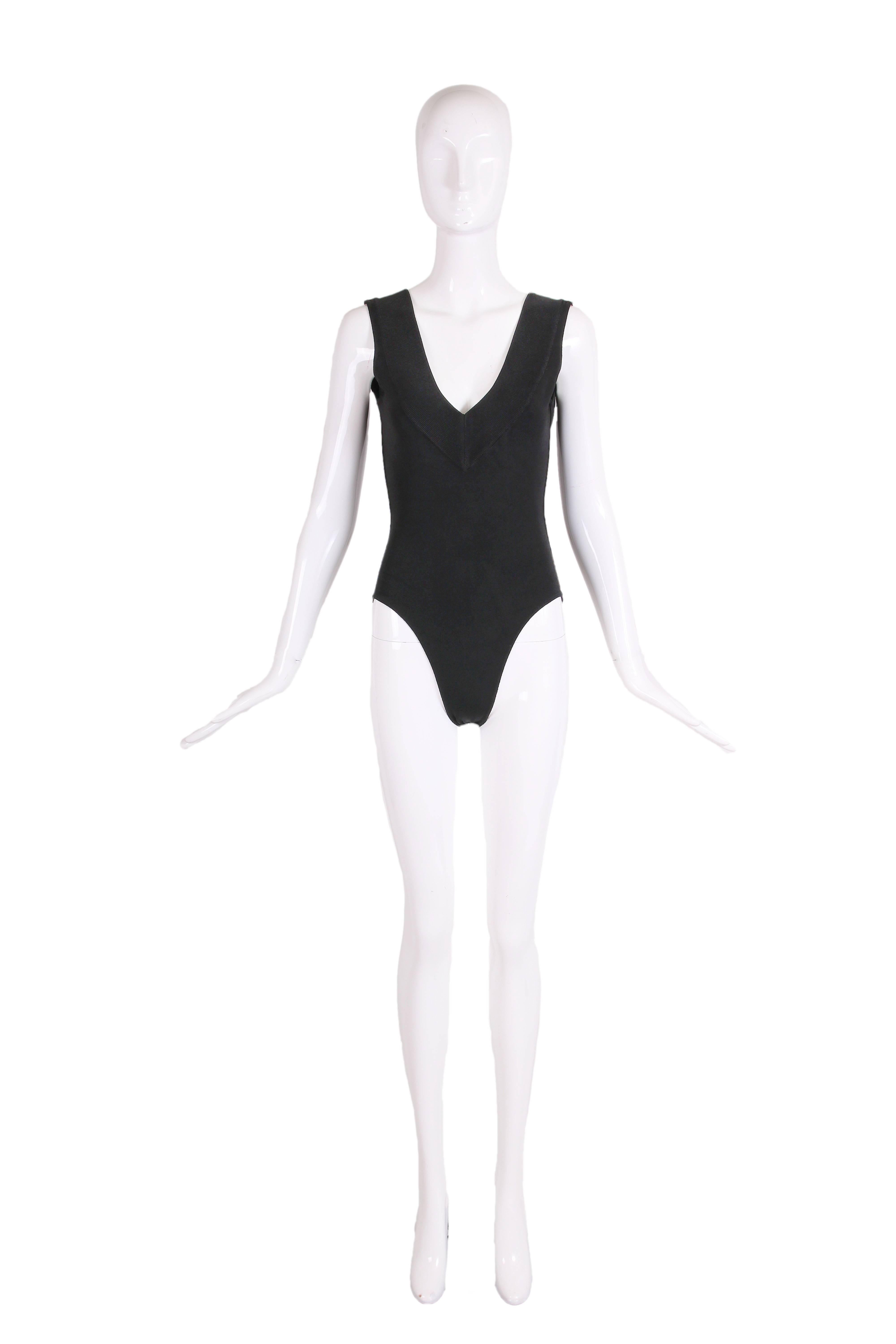 1990's Azzedine Alaia black stretch body suit with deep v-neckline at back and front. There are three snap closures at the bottom. In excellent condition - tag size Small - please consult measurements.