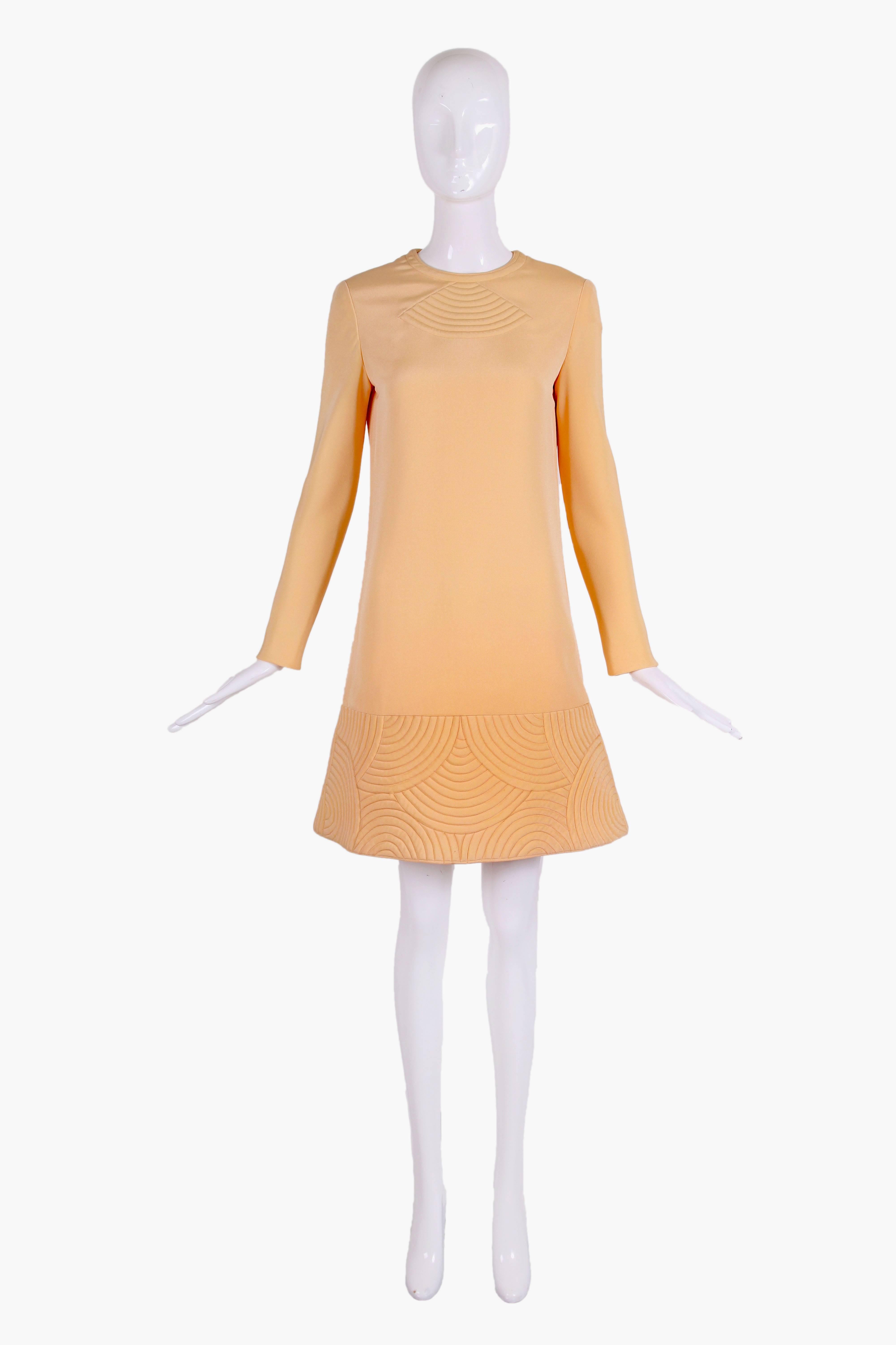 1970's Pierre Cardin Seide Space Age Minikleid in einem blassen Pfirsich / Sherbert Farbe. Das Kleid hat ein klassisches, gestepptes geometrisches Cardin-Muster am Saum und in der Mitte der Brust. In ausgezeichnetem Zustand - siehe