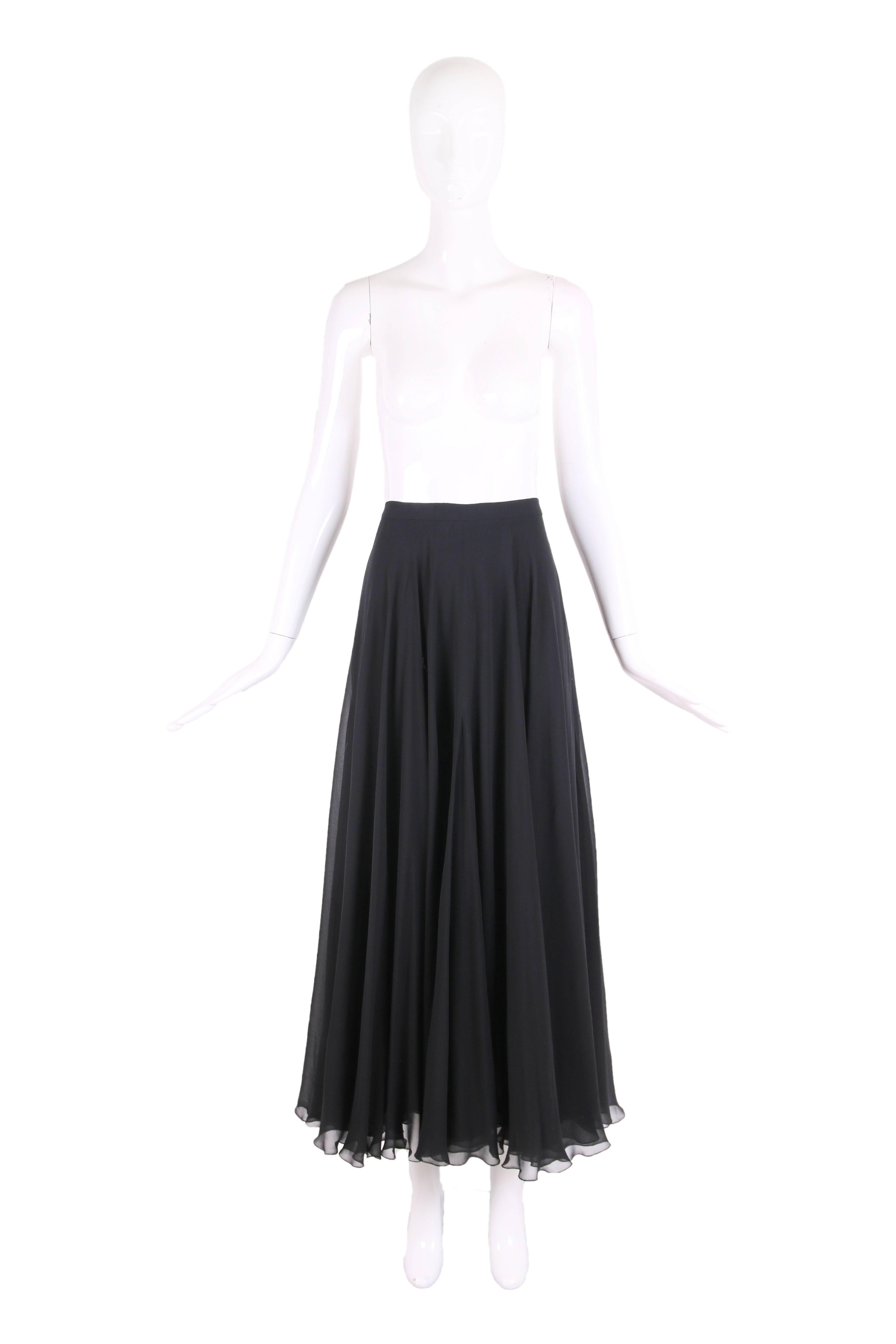 1993 Chanel black silk chiffon triple layered flared maxi skirt w/gold tone CC logo button at waist and side zipper closure. In very good to excellent condition with three tiny nicks in the fabric at the waist band in one small area. Missing the