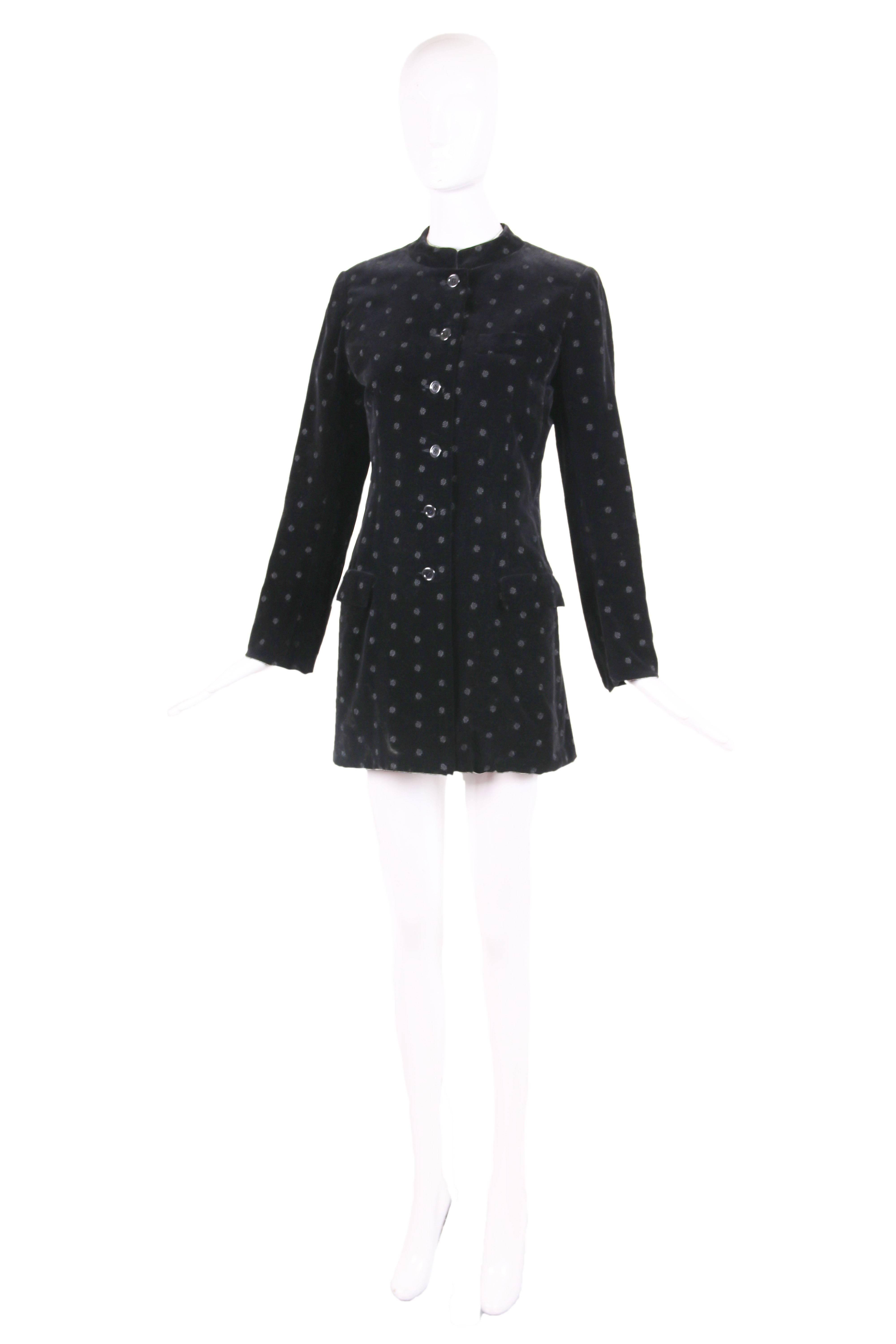 1970's Yves Saint Laurent black velvet jacket with Nehru collar and rose pattern. Jacket buttons down center front and features two flap pockets at the bodice front below the waist and one breast pocket. There is a vent at the back. In excellent
