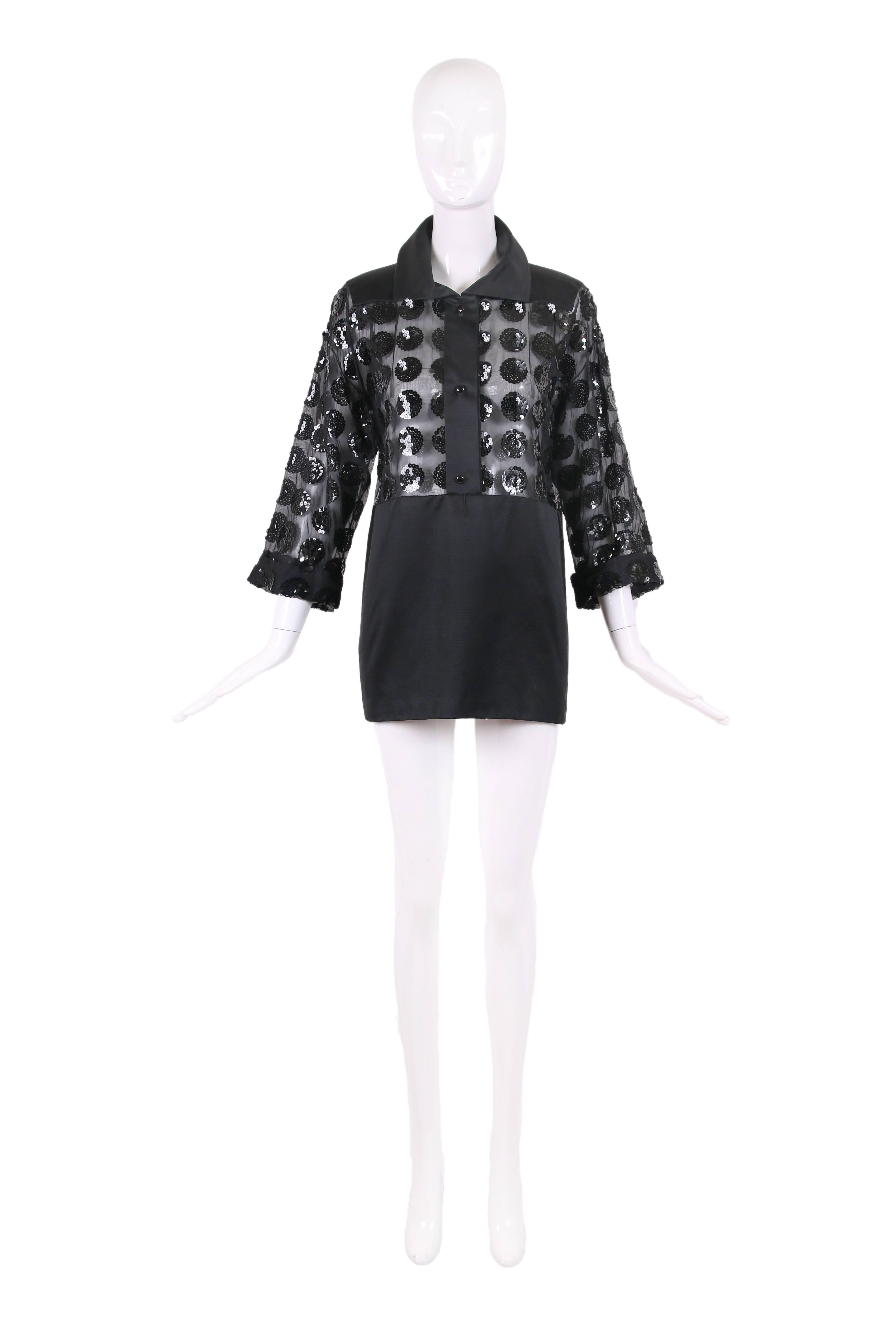 Vintage Courreges black mini dress with sheer bodice covered with a pattern of circular sequins and a mini skirt made from either black satin or black polished cotton - there is no fabric tag. No size tag. In excellent condition - missing waist belt.