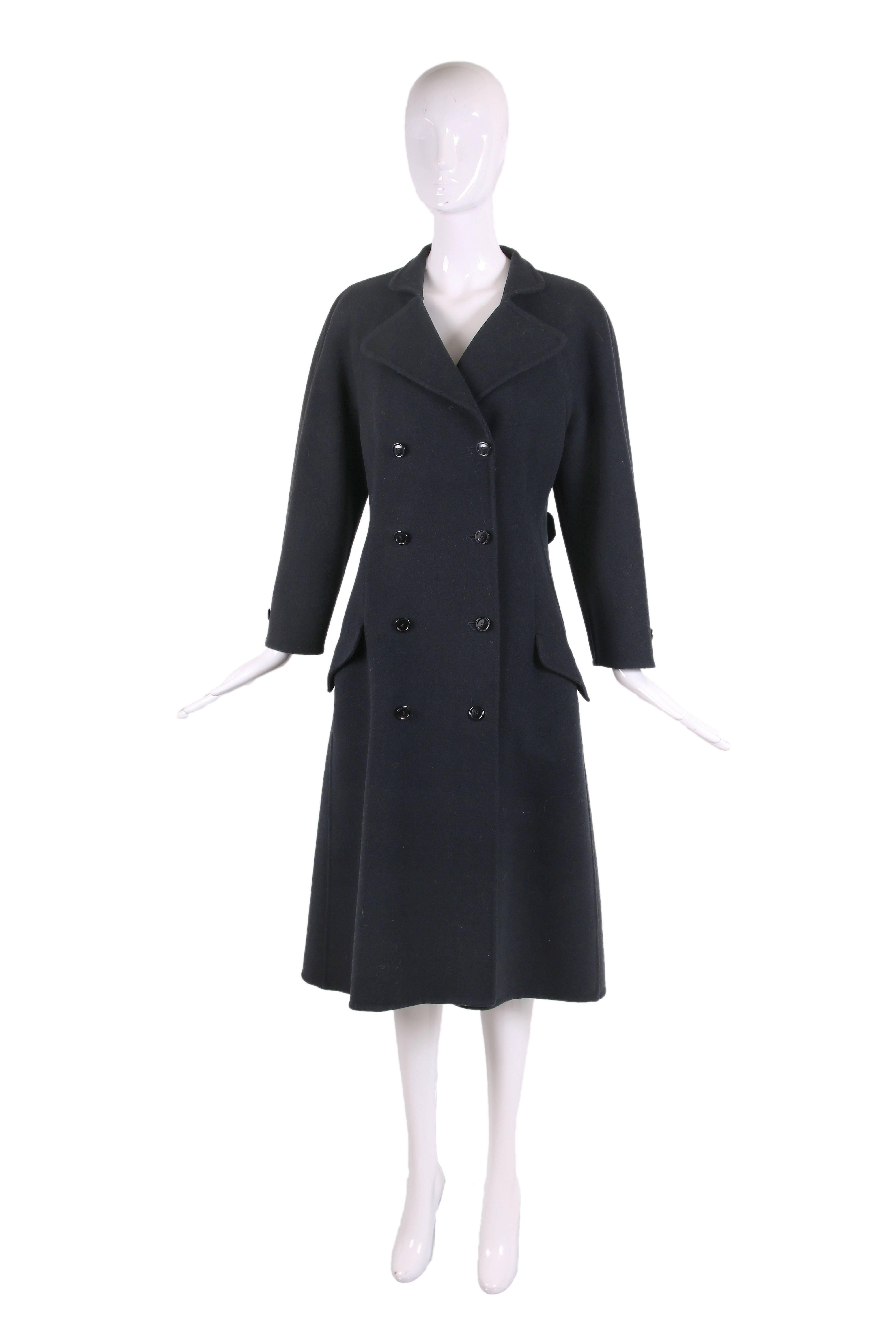 1970's Halston black wool double-breasted coat with raglan sleeves, two frontal flap pockets and bar tab at back. In excellent condition. No size or fabric tag - please consult measurements. 
MEASUREMENTS:
Bust - 40